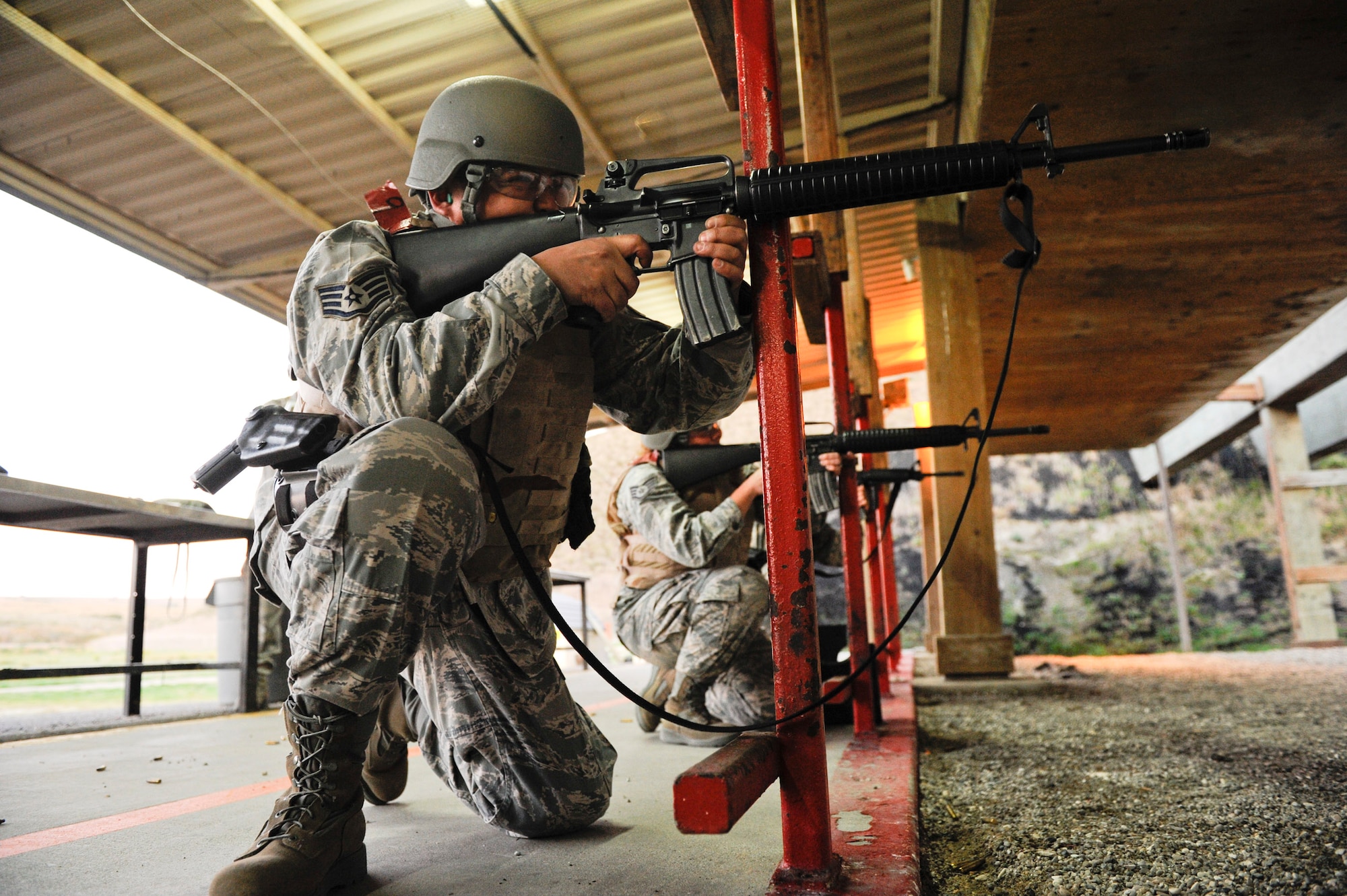 VANDENBERG AIR FORCE BASE, Calif. -- Staff Sgt. Bien Covita, a 30th Comptroller Squadron deputy dispersing officer, fires an M16 rifle during the first class of the new Rifle Carbine Air Force Qualification course here Tuesday, Dec. 6, 2011. The new course, in which Airman fire nearly double the amount of rounds of the previous course, contains both basic firing positions (prone, sitting, kneeling, standing) and advanced tactical movements. (U.S. Air Force/Staff Sgt. Levi Riendeau)