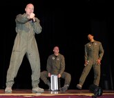 From left to right, Master Sergeants Ryan Carson, vocalist, Dennis W. Hoffmann, drummer, and Shani Prewitt, vocalist, U.S. Air Force Band’s Max Impact ensemble, perform the rap song “tools” Nov. 30 for Bladensburg High School’s Junior Reserve Officer Training Corps cadets, Bladensburg, Md. (U.S. Air Force photo by Staff Sgt. Christopher Ruano)
