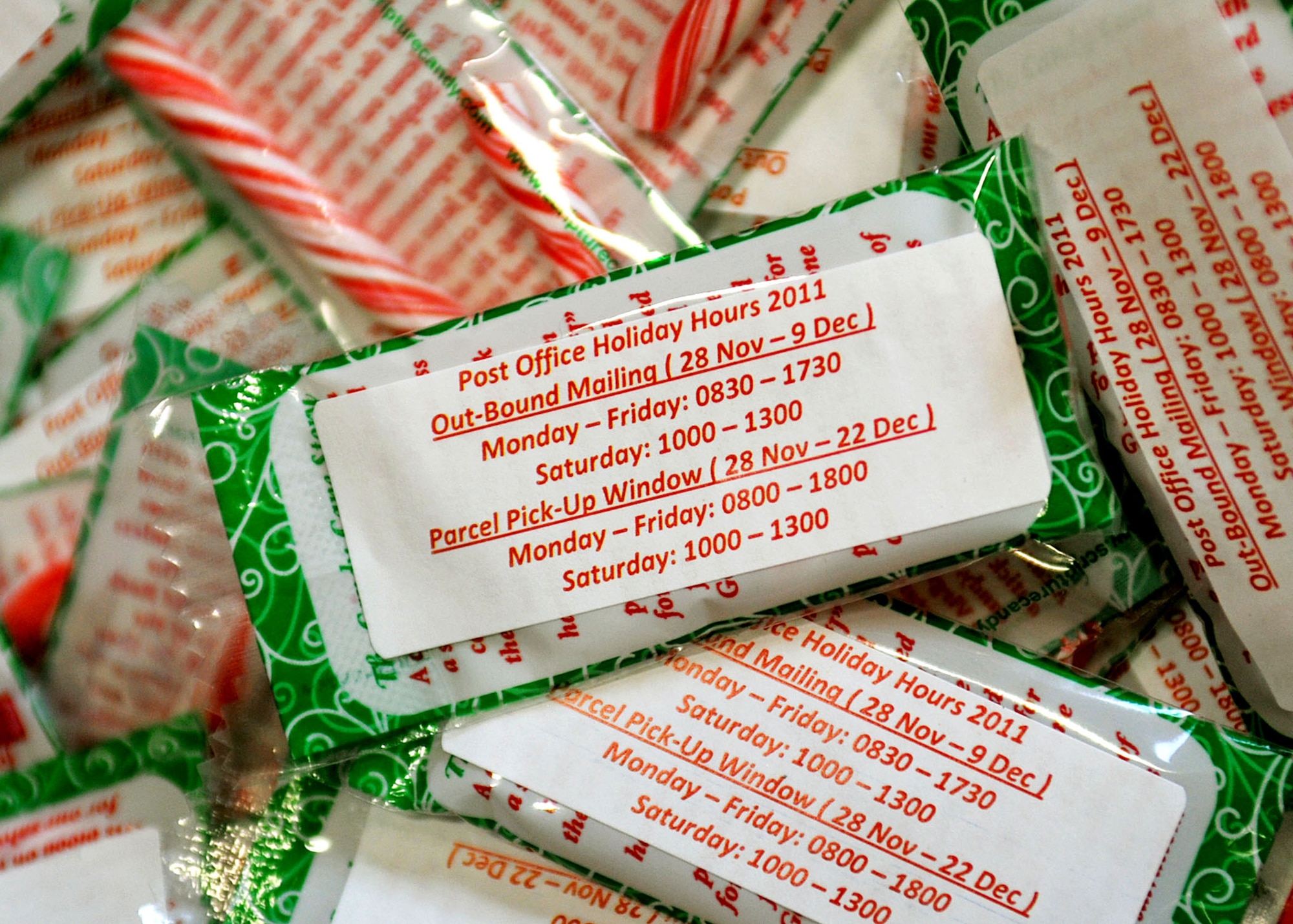 RAF MILDENHALL, England - Candy canes advertise the post office's modified hours of operation for the upcoming holiday season. Santa Claus distributed the candy to patrons Dec. 6, 2011 at the post office during normal operating hours. (U.S. Air Force photo/Senior Airman Jerilyn Quintanilla)