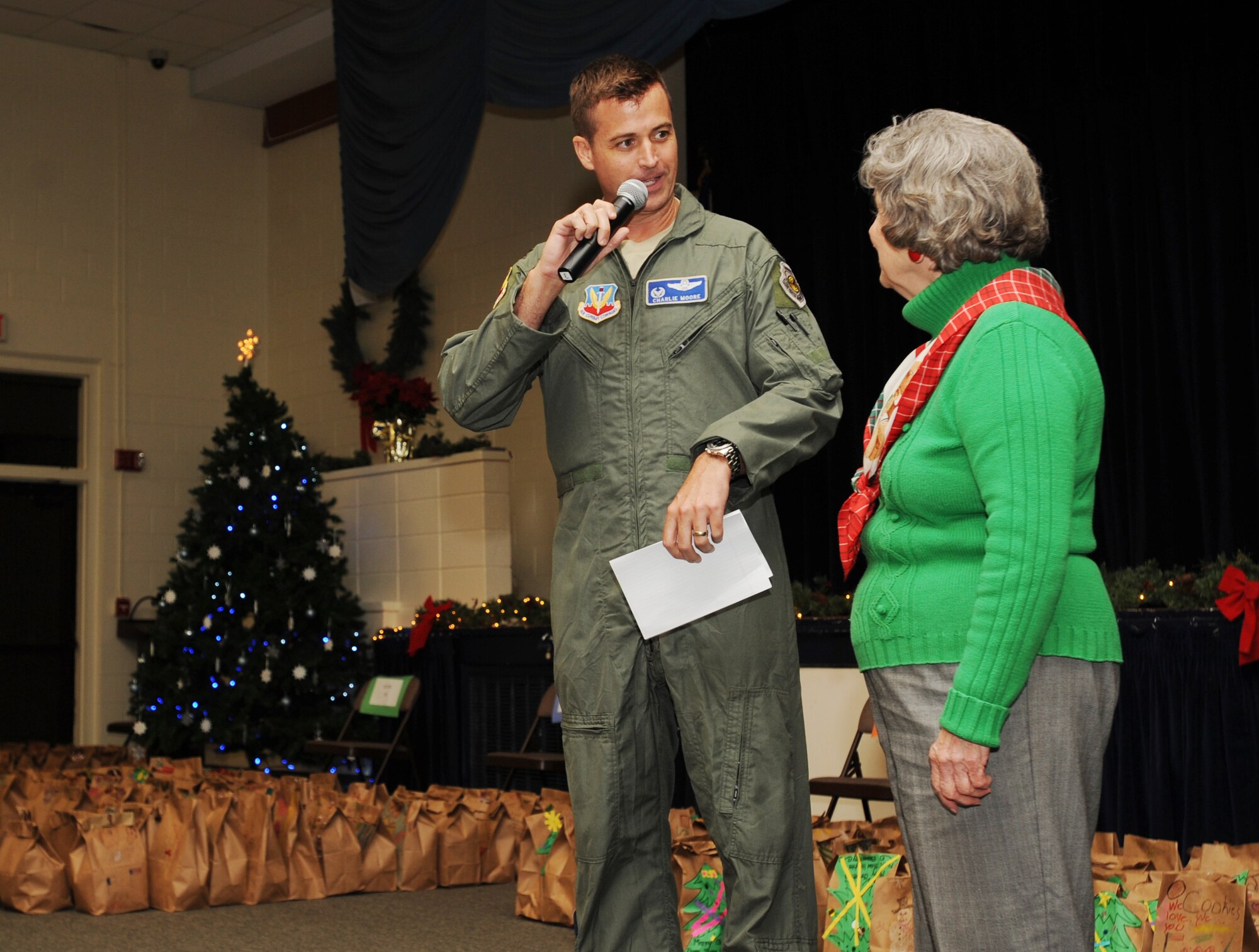 U.S. Air Force Col. Charlie Moore, 20th Fighter Wing commander, thanks Joanne Morris, cookie drive coordinator, for her support for this event since 1993 at the community center at Shaw Air Force Base, S.C., Dec. 7, 2011. The cookie drive is an annual program designed to give Christmas cookies to deployed Airmen as well as Airmen in the dorms. (U.S. Air Force photo by Airman 1st Class Tabatha Duarte/Released)