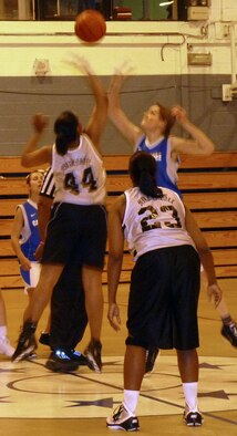 RAF MILDENHALL, England -- The joint RAF Mildenhall and RAF Lakenheath Lady Eagles team (white) and Cambridge Lady Panthers tip off in an exhibition game at the North Side Fitness Center here Dec. 1, 2011. The Lady Eagles took the game 42-17. (Courtesy photo)
