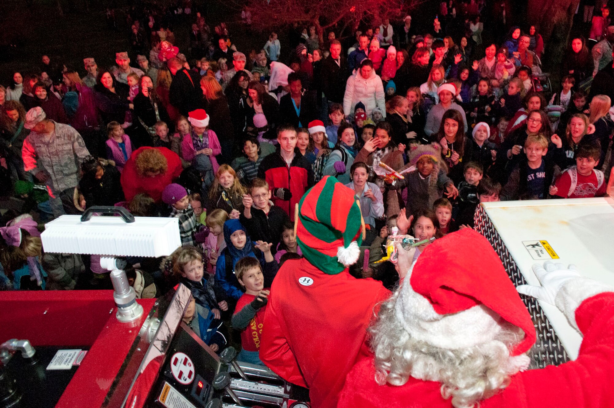 HANSCOM AIR FORCE BASE, Mass. – Santa Claus and his elves arrive on a fire truck to deliver candy to children and adults during the Christmas Tree Lighting ceremony at the base chapel Dec. 1. The event also included performances by the Hanscom Bell Choir and Band of Liberty, as well as a chance enjoy refreshments and take photos with Santa.(U.S. Air Force photo by Mark Wyatt)