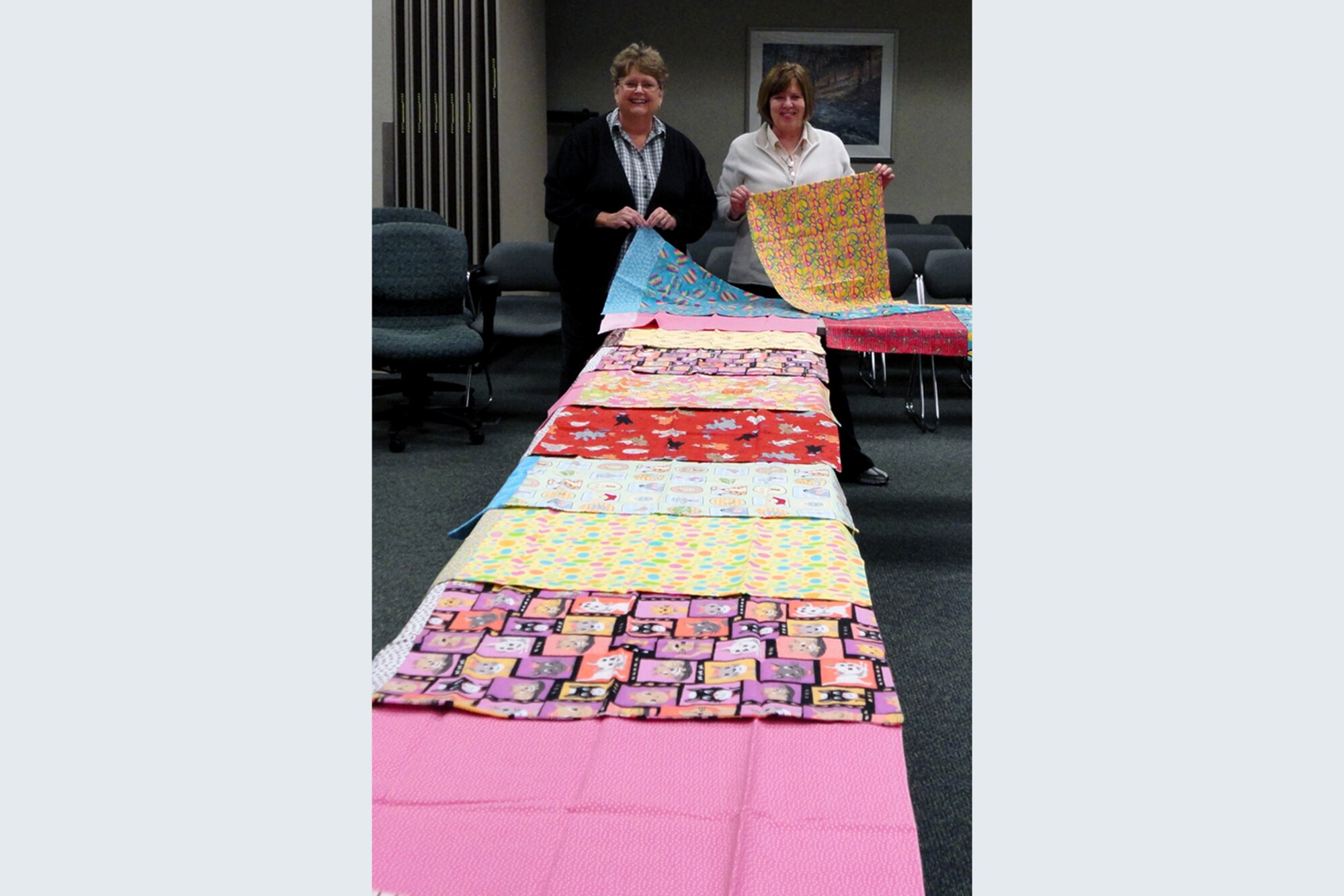 GRISSOM AIR RESERVE BASE, Ind. -- Sue Phillips, left and Alice Vail, both members of the 434th Civil Engineer Squadron, display pillowcases they're working on for children with cancer. The two seamstresses made nearly 30 pillowcases in September for donation to Riley Children's Hospital and Peyton Manning Children's Hospitals. (U.S. Air Force photo/Senior Master Sgt. John Somsel)
