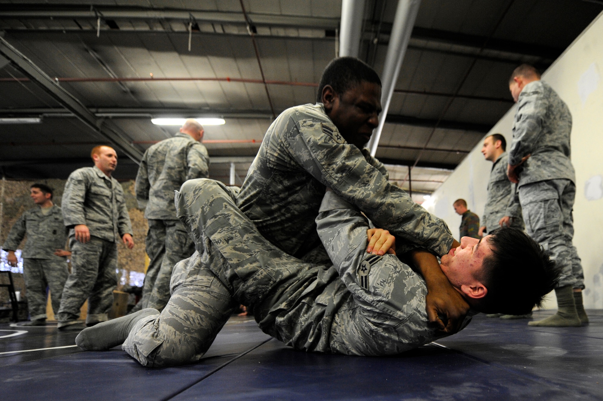 Air Force Airman 1st Class Stephen Buesing and Air Force Airman 1st Class Darren Joyner, 86th Security Forces Squadron members, practice flyaway security team ground combat training Dec. 07, 2011, Ramstein Air Base, Germany.  The F.A.S.T specialize in military teams that are in support of contingencies, theater security operation events, humanitarian and civic assistance projects, AEF deployments, and military operations other than war. (U.S. Air Force photo by Staff Sgt. Chris Willis)