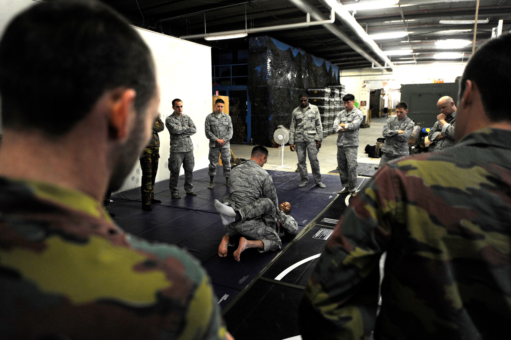 Air Force Staff Sgt. Christopher Whiting and Air Force Staff Sgt. Daniel Weisel, 435th Security Forces Squadron Creek Defender instructors, demonstrate their modified army combative technique during a flyaway security team practice session Dec. 07, 2011, Ramstein Air Base, Germany.  As part of the 435th wing's Contingency Response Group, the 435th SFS contributes to the group's "open the base" mission, as well as expeditionary combat support training through the USAFE Security Forces Regional Training Center's Creek Defender course. (U.S. Air Force photo by Staff Sgt. Chris Willis)