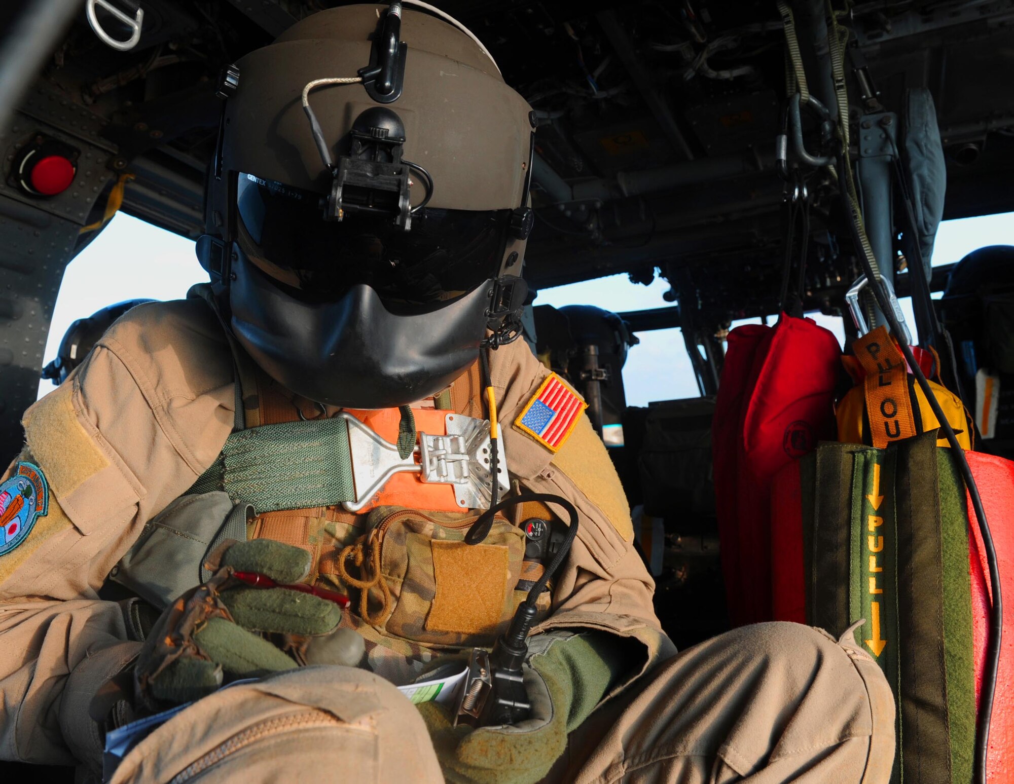 U.S. Air Force Tech. Sgt. Scott Lagerveld, 33rd Rescue Squadron A-Flight chief, writes down notes on how the day's training is going during a training mission in Okinawa, Japan, Dec. 7, 2011. The 33rd RQS took part in the 12th annual exercise Cope Angel; the training took place both on land and over water. (U.S. Air Force photo by Airman 1st Class Brooke P. Beers/Released)