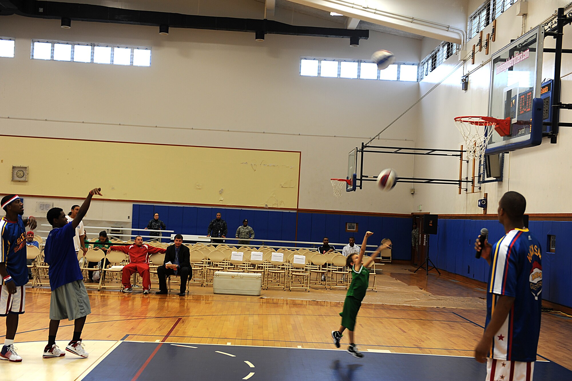 The Harlem Globetrotters play a game of knockout with children at the Risner Fitness Center on Kadena Air Base, Japan, Dec. 6, 2011. The Harlem Globetrotters held a children's skills camp to teach basketball fundamentals as well as different tricks. (U.S. Air Force photo by Airman 1st Class Justin Veazie/Released)