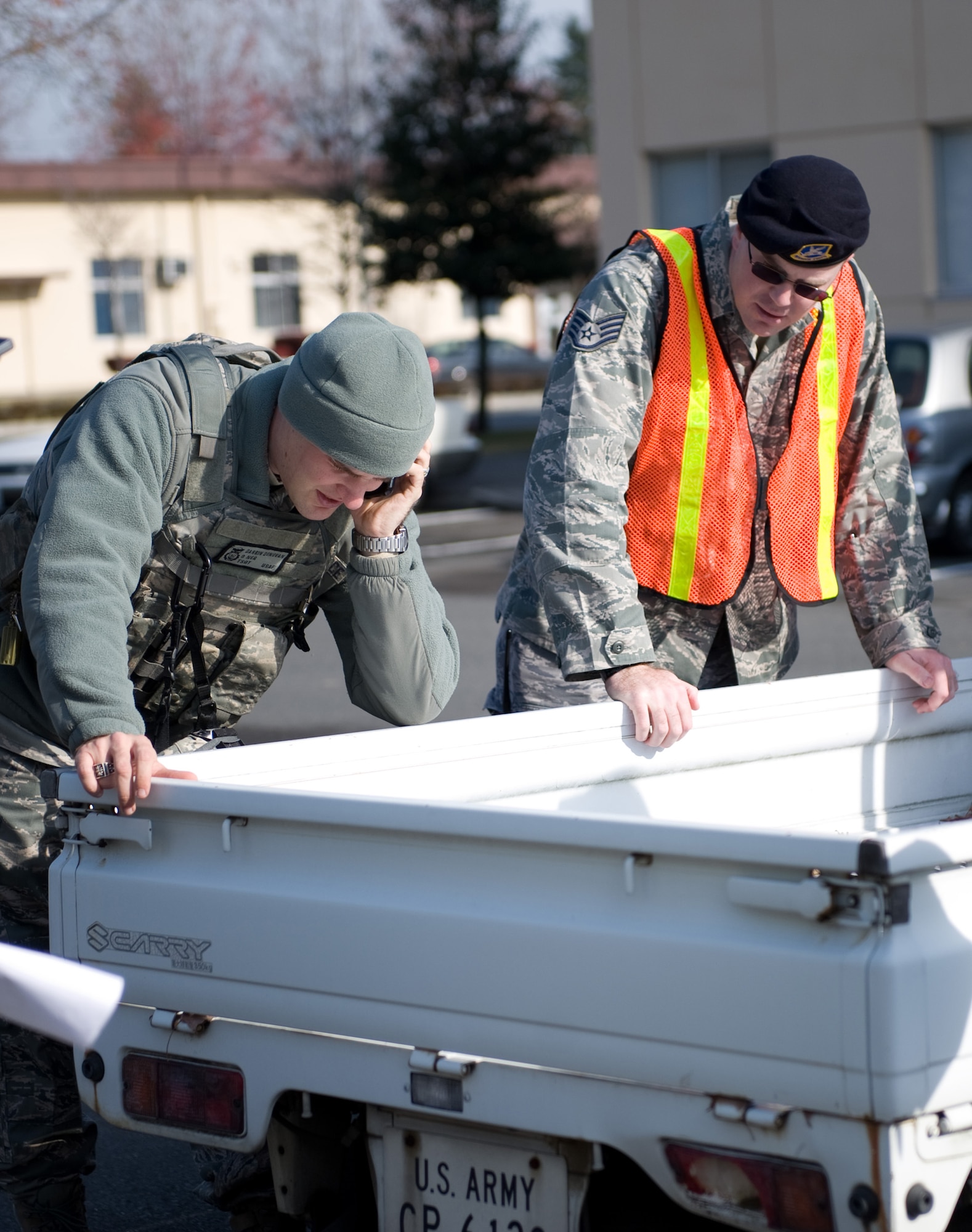 YOKOTA AIR BASE, Japan -- (Left to right) Tech. Sgt. Darrin Donovan and Staff Sgt. Davy Huffman, both members of the 374th Security Forces Squadron, call in the "all clear" for the buildings at Yokota Air Base, Japan, Dec. 7, 2011. Several buildings were evacuated prior to a detonation of an unexploded ordnance, found at a construction site at Yokota on Dec. 6, 2011. (U.S. Air Force photo/Airman 1st Class Krystal M. Garrett)