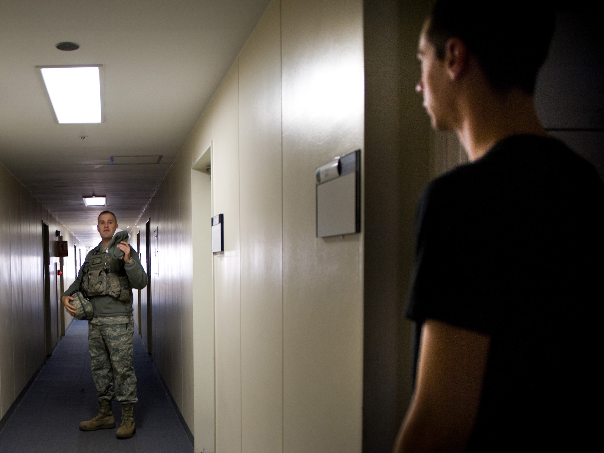 YOKOTA AIR BASE, Japan -- Tech. Sgt. Darrin Donovan, 374th Security Forces Squadron, notifies a dorm resident to immediately evacuate the building , at Yokota Air Base, Japan, Dec. 7, 2011. Several buildings were evacuated prior to a detonation of an unexploded ordnance, found at a construction site at Yokota on Dec. 6, 2011. (U.S. Air Force photo/Airman 1st Class Krystal M. Garrett)