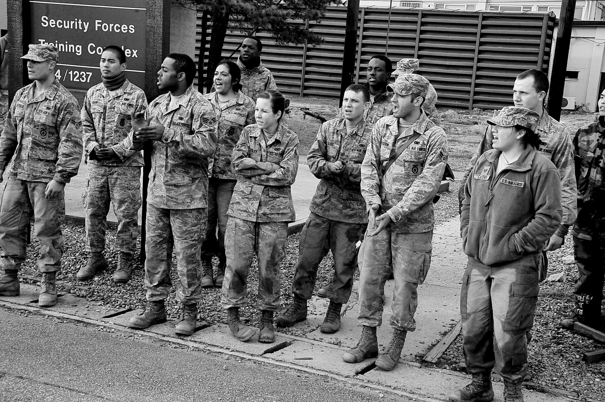 Members of the 51st Security Forces Squadron, cheer on their fellow class mates as the close in on the finish line during the confidence course portion of the Combat Readiness Course Dec.05, 2011. The confidence course is an obstacle course that tests the participant’s abilities to survive as a team while communicating when placed in stressful situations. (U.S. Air Force photo/Senior Airman Adam Grant)
