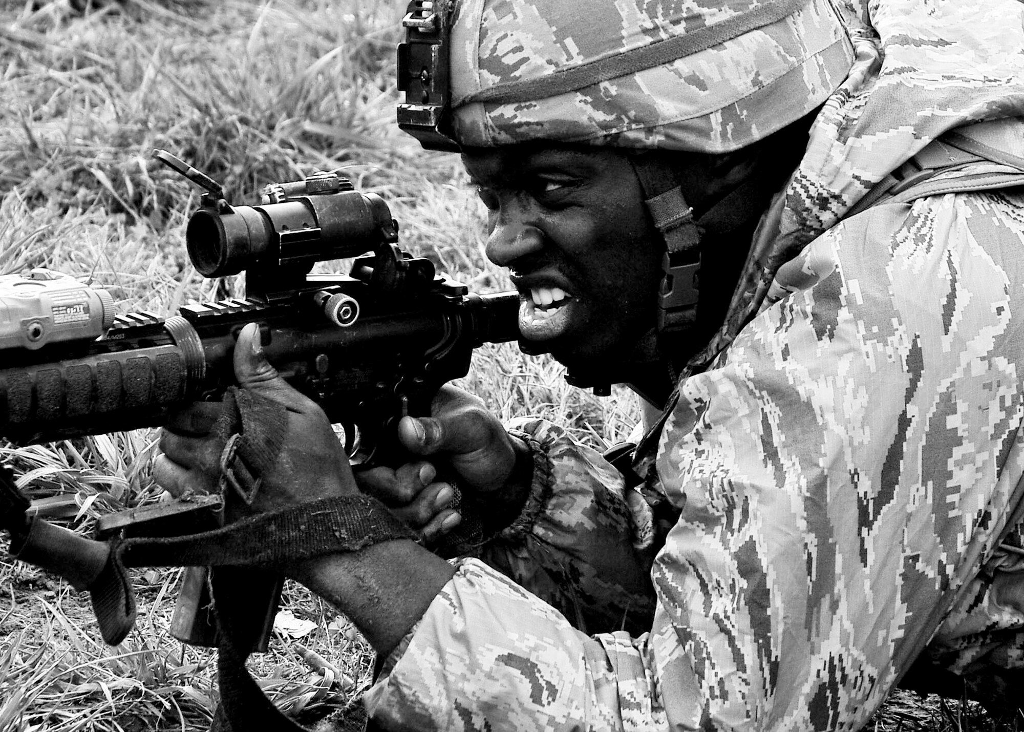 Staff Sgt. Maurice Williams, 51st Security Forces Squadron member, provides security while his firing squad is under contact during the confidence course portion of the Combat Readiness Course Dec. 05, 2011. During the confidence course members answer knowledge questions, perform sprints, tire rolls, low crawl for 30 yards, maneuver over an 8-foot wall, litter carry and injured team member for 400 meters and compete in a weapons challenge. (U.S. Air Force photo/Senior Airman Adam Grant)