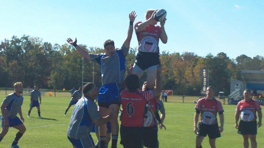 FORT BENNING, Ga. - Capt. Nathan Terrazone (being lifted on left), Upgrades Early Warning Radar and COBRA DANE project manager, and Capt. Brandon Conyers (lifting on left), Enhanced Land/Maritime Mode program manager, work together during a "line-out" at the 2011 Armed Forces Rugby Tournament. Air Force placed first in the tournament held Nov. 2 through 5. (Courtesy photo)
