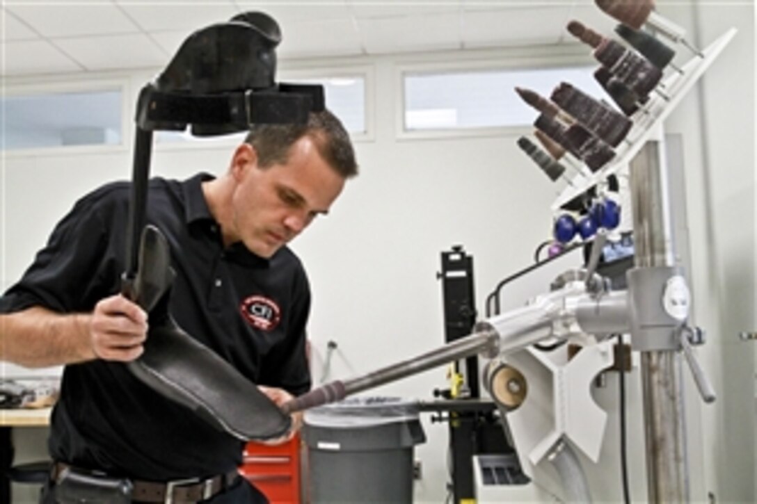 Ryan Blanck, a prosthetist and developer of the Intrepid Dynamic Exoskeletal Orthosis brace, checks the fit after he adjusts one of his braces on Army 1st Lt. Matthew Anderson, an infantry platoon leader, at the Center for the Intrepid in San Antonio, Nov. 10, 2011. 
