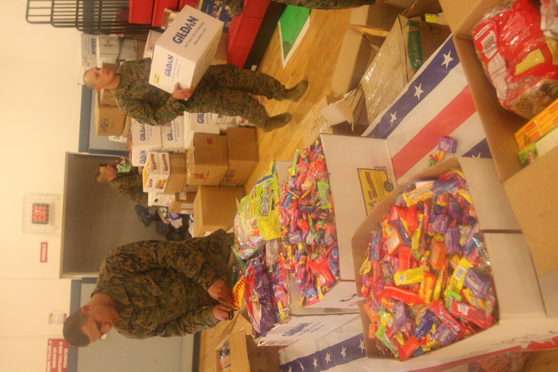 Private Louis Acampora works alongside his fellow Marines from Truck Company B to prep the candy and presents that will be given to wounded veterans and their families during Operation Wounded Warrior.  The operation is an annual event held by firefighters from Nassau County and is hosted at several military bases along the east coast.