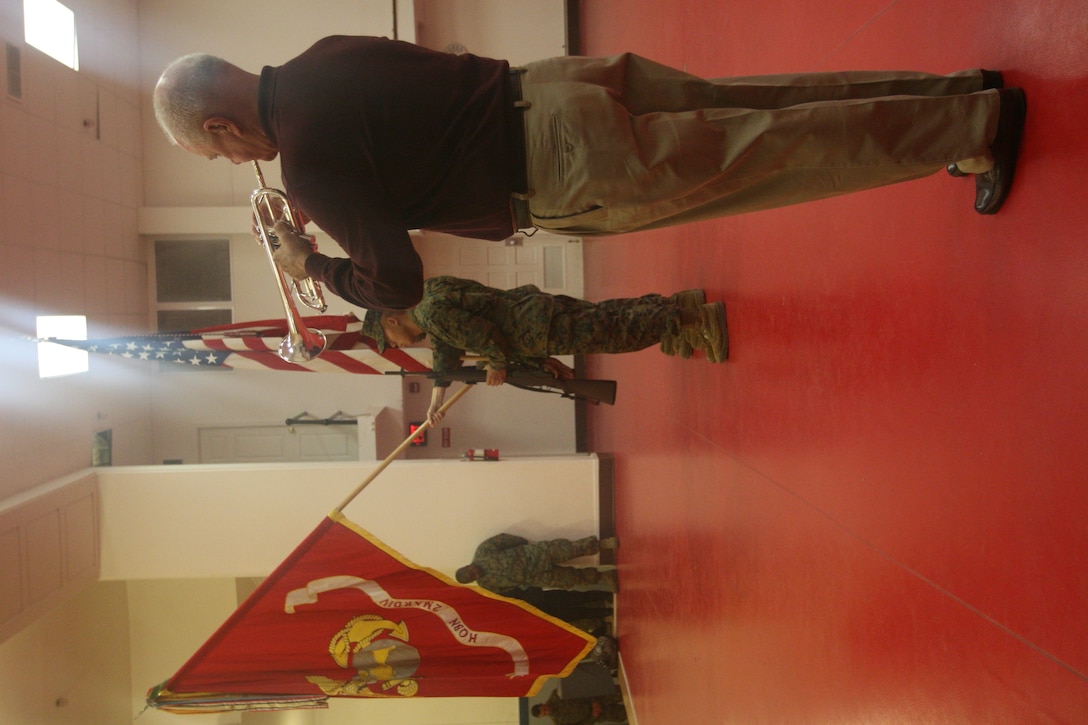 Former Senior Airman Dan Jones plays Taps on his trumpet while Marines present the colors at the start of Operation Wounded Warriors ceremony.   Jones has been playing the trumpet for ceremonies like OWW since his days in high school in the 1960’s.