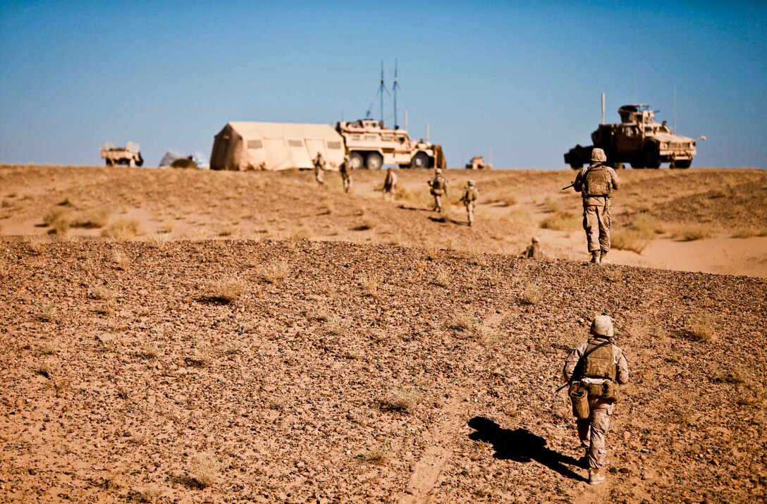 Marines with Team 1, Border Advisor Team 1, patrol to the mobile combat operations center during Operation Eagle Hunt.  Day one of the operation started off for the Marines with a three-mile trek through sandy plains before reaching a compound they would later call home for the majority of the mission.  The team’s mission was to support the Afghan Border Police and Afghan Uniformed Police, who spearheaded the operation.