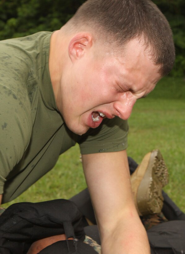 2nd Lt. Dave Baugh, the deputy public affairs officer for the 31st Marine Expeditionary Unit, struggles to open his eyes while executing a takedown during an oleoresin capsicum spray training event with Combat Logistics Battalion 31 here, Dec. 9.  The OC training certifies Marines to be military police augments for the MEU and to carry OC spray.  The 31st MEU remains the United States’ force in readiness in the Asia-Pacific region, and is the only continually forward-deployed MEU.