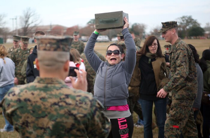 A spouse lifts an ammunition can over head during Jane Wayne Day with Combat Logistics Regiment 27, 2nd Marine Logistics Group at W.P.T. Hill Field aboard Camp Lejeune, N.C., Dec. 9, 2011. During the event, spouses participated in a modified combat fitness test, fired rifles and learned basic Marine Corps Martial Arts Program moves. (U.S. Marine Corps photo by Pfc. Franklin E. Mercado)