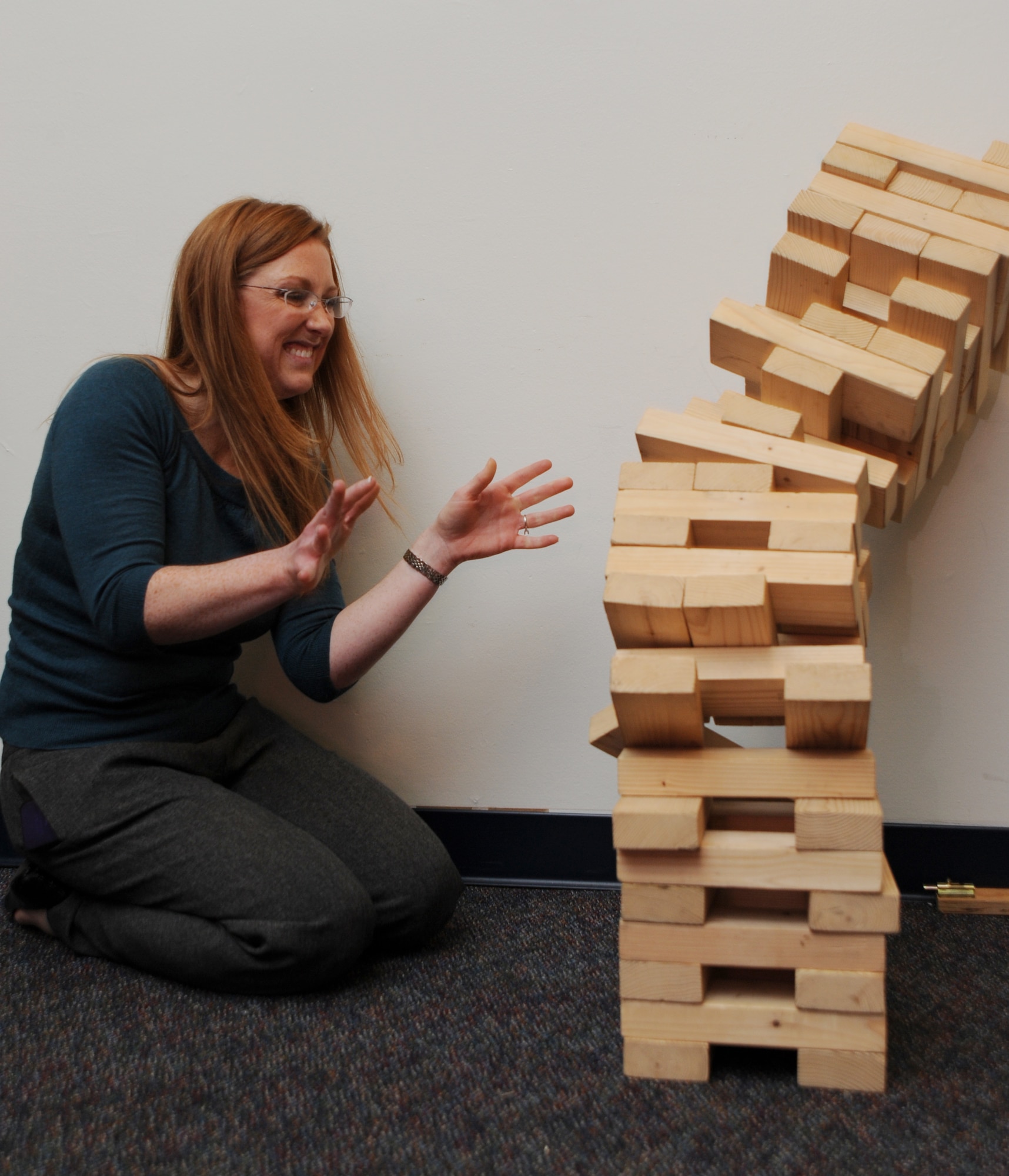 Erica Glon, Air Force District of Washington chief of community relations, fails at Jenga Dec. 8 at the USO pizza party on Joint Base Andrews, Md. The party had games and prizes for all servicemembers on JBA. (U.S. Air Force photo by Staff Sgt. Christopher Ruano)