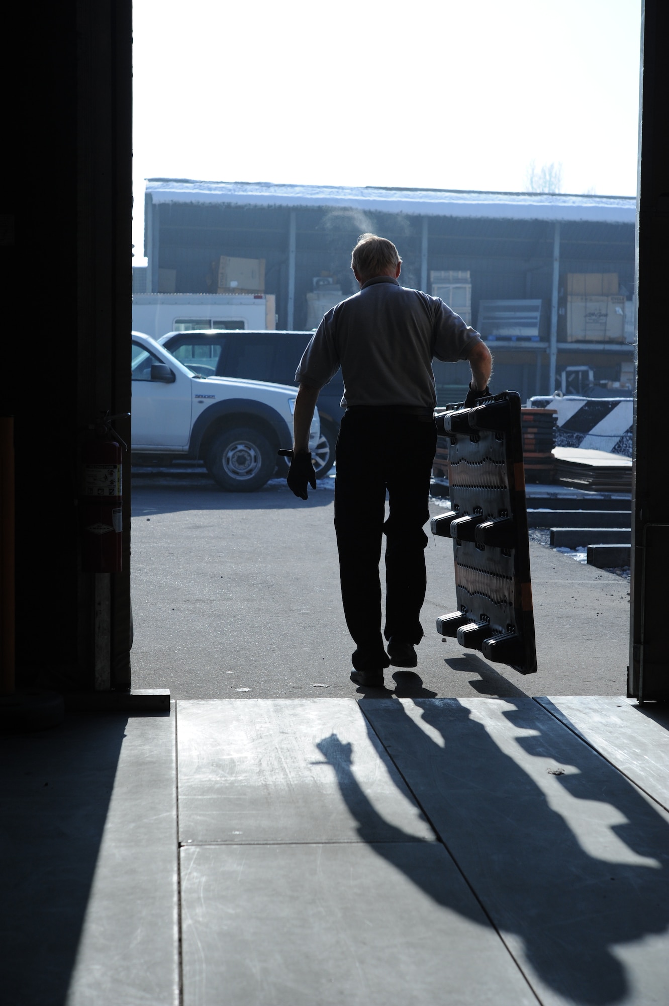 Richard Hayes, 376th Expeditionary Communications Squadron postal technician, takes a pallet out to be stored for later use by the post office at the Transit Center at Manas, Kyrgyzstan, Dec. 9, 2011. The post office processes all mail for deployed service members, Department of Defense contractors, transient personnel and the U.S. Embassy in Bishkek. (U.S. Air Force Photo/Tech. Sgt. Hank Hoegen)