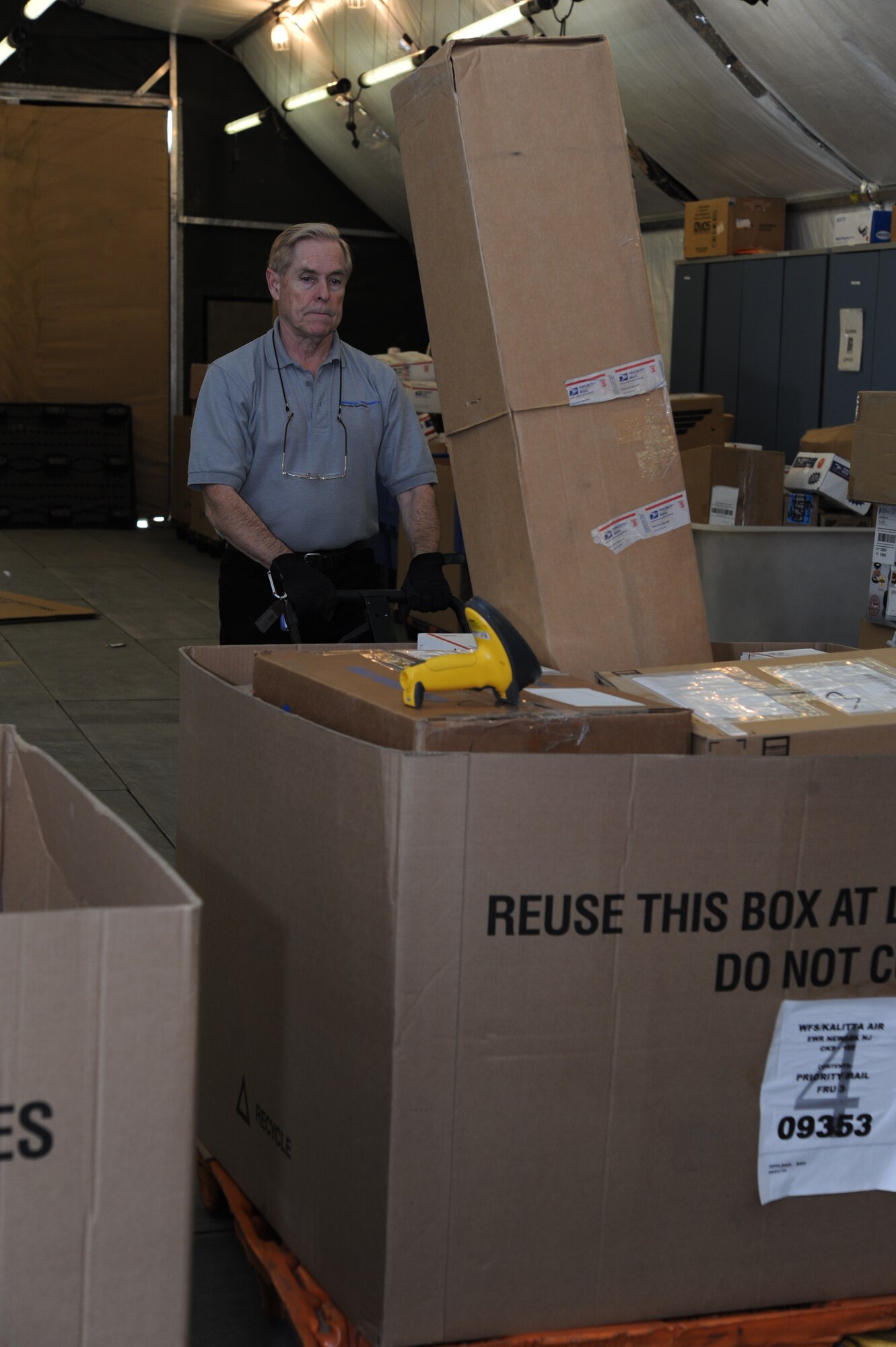 Richard Hayes, 376th Expeditionary Communications Squadron postal technician, moves mail pallets after sorting received mail at the post office at the Transit Center at Manas, Kyrgyzstan, Dec. 9, 2011. The post office processes all mail for deployed service members, Department of Defense contractors, transient personnel and the U.S. Embassy in Bishkek. (U.S. Air Force Photo/Tech. Sgt. Hank Hoegen)