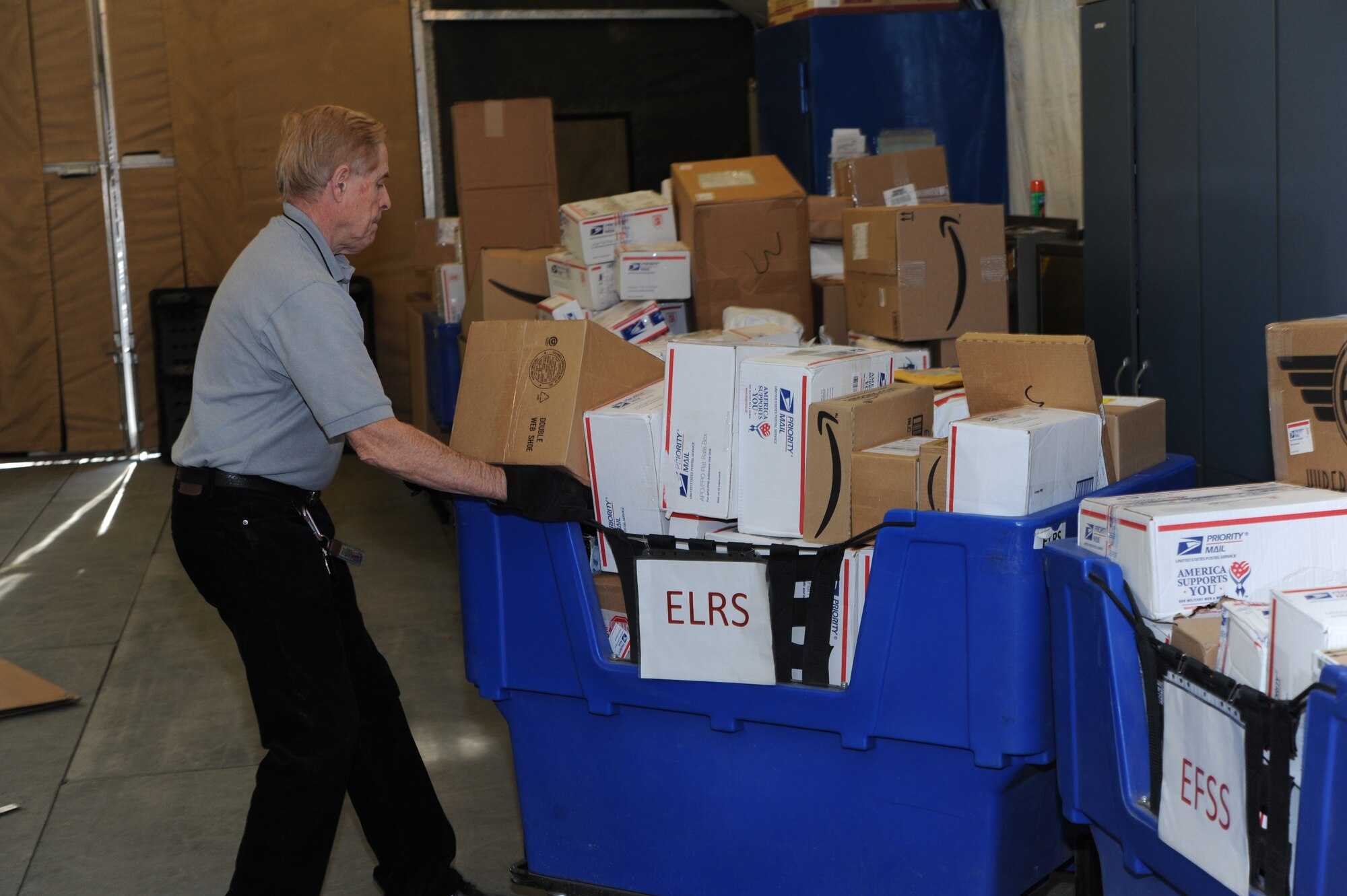 Richard Hayes, 376th Expeditionary Communications Squadron postal technician, realigns mail bins after sorting mail at the post office at the Transit Center at Manas, Kyrgyzstan, Dec. 9, 2011. The post office here receives an average of 1,600 pieces of mail a day. (U.S. Air Force Photo/Tech. Sgt. Hank Hoegen)