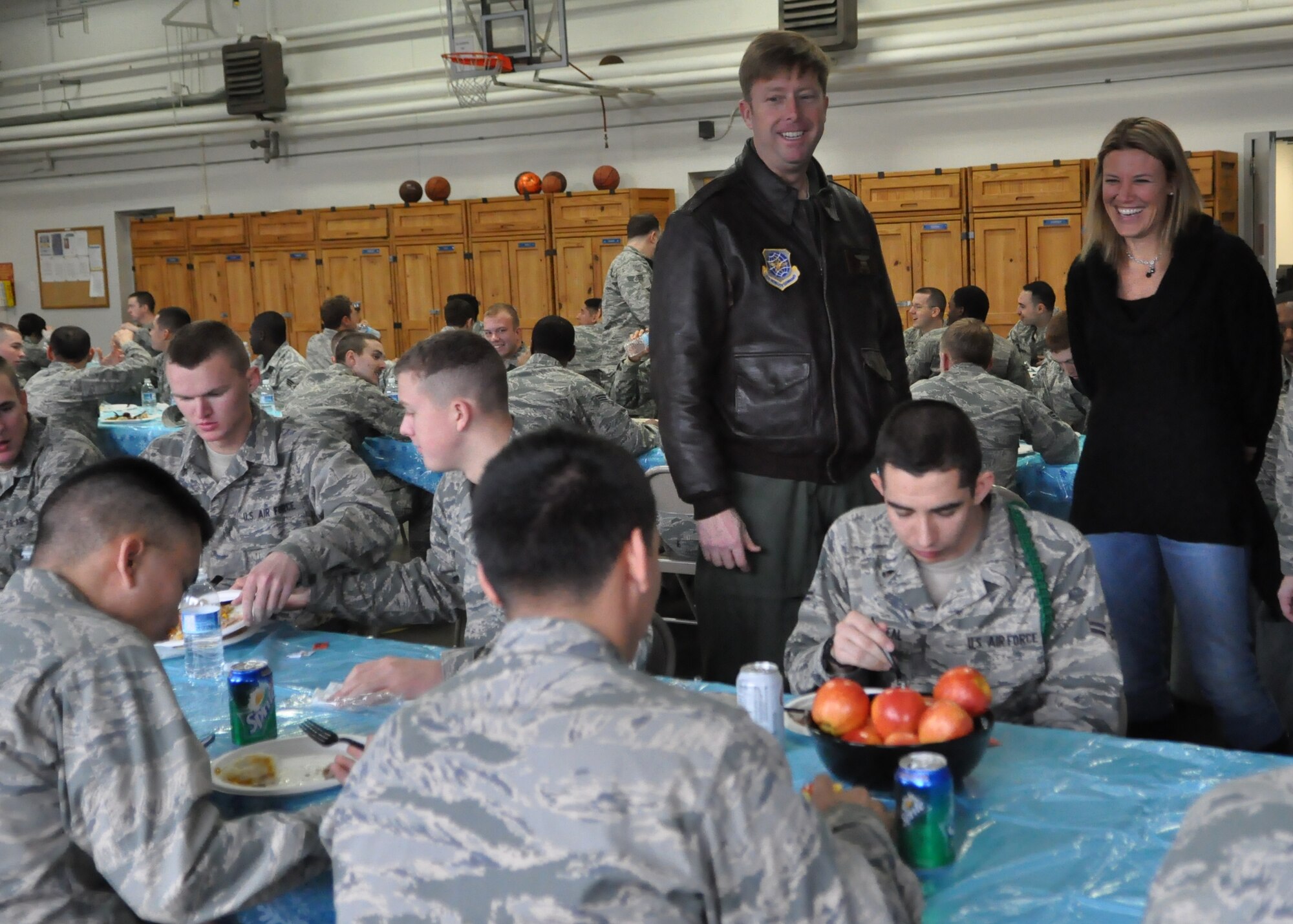 Col. Wyn Elder, 62nd Airlift Wing commander, and his wife, Maggie, speak to Airmen Dec. 9, 2011, during the fourth annual Unaccompanied Airmen Holiday Feast at Joint Base Lewis-McChord, Wash. (U.S. Air Force photo/Airman 1st Class Leah Young)