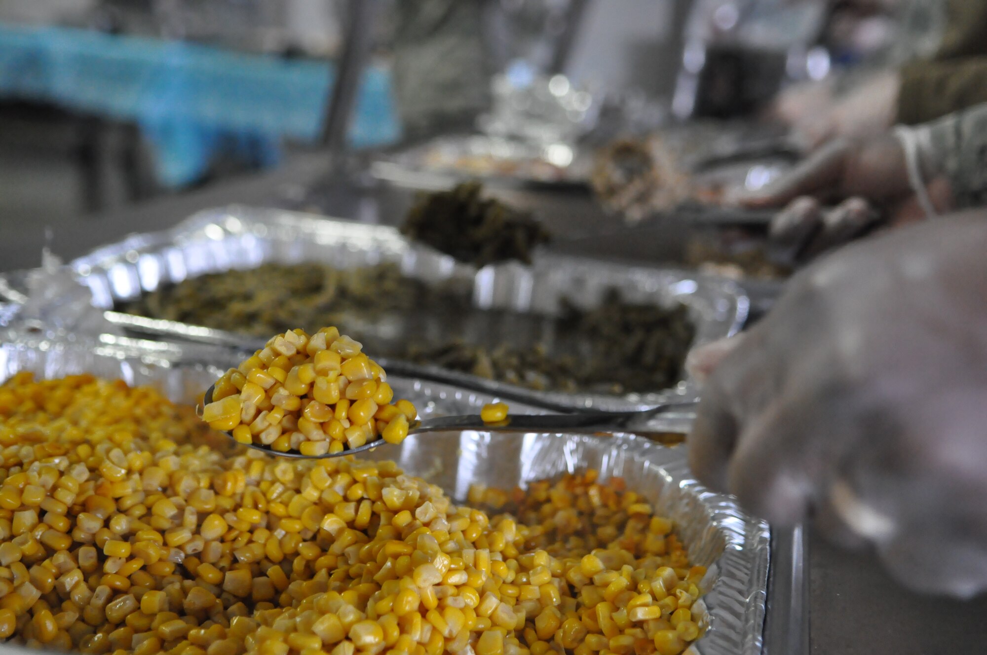 Members of the first sergeant council served Airmen a meal including vegetables, turkey, mashed potatoes and more Dec. 9, 2011, during the fourth annual Unaccompanied Airmen Holiday Feast at Joint Base Lewis-McChord, Wash. (U.S. Air Force photo/Airman 1st Class Leah Young)