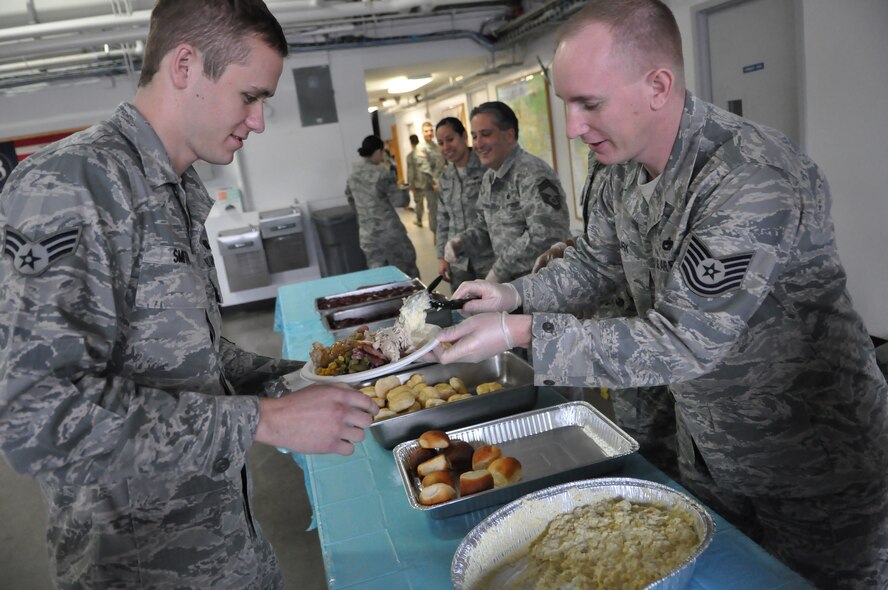 First sergeants serve lunch to an Airman Dec. 9, 2011, during the fourth annual Unaccompanied Airmen Holiday Feast at Joint Base Lewis-McChord, Wash. (U.S. Air Force photo/Airman 1st Class Leah Young)