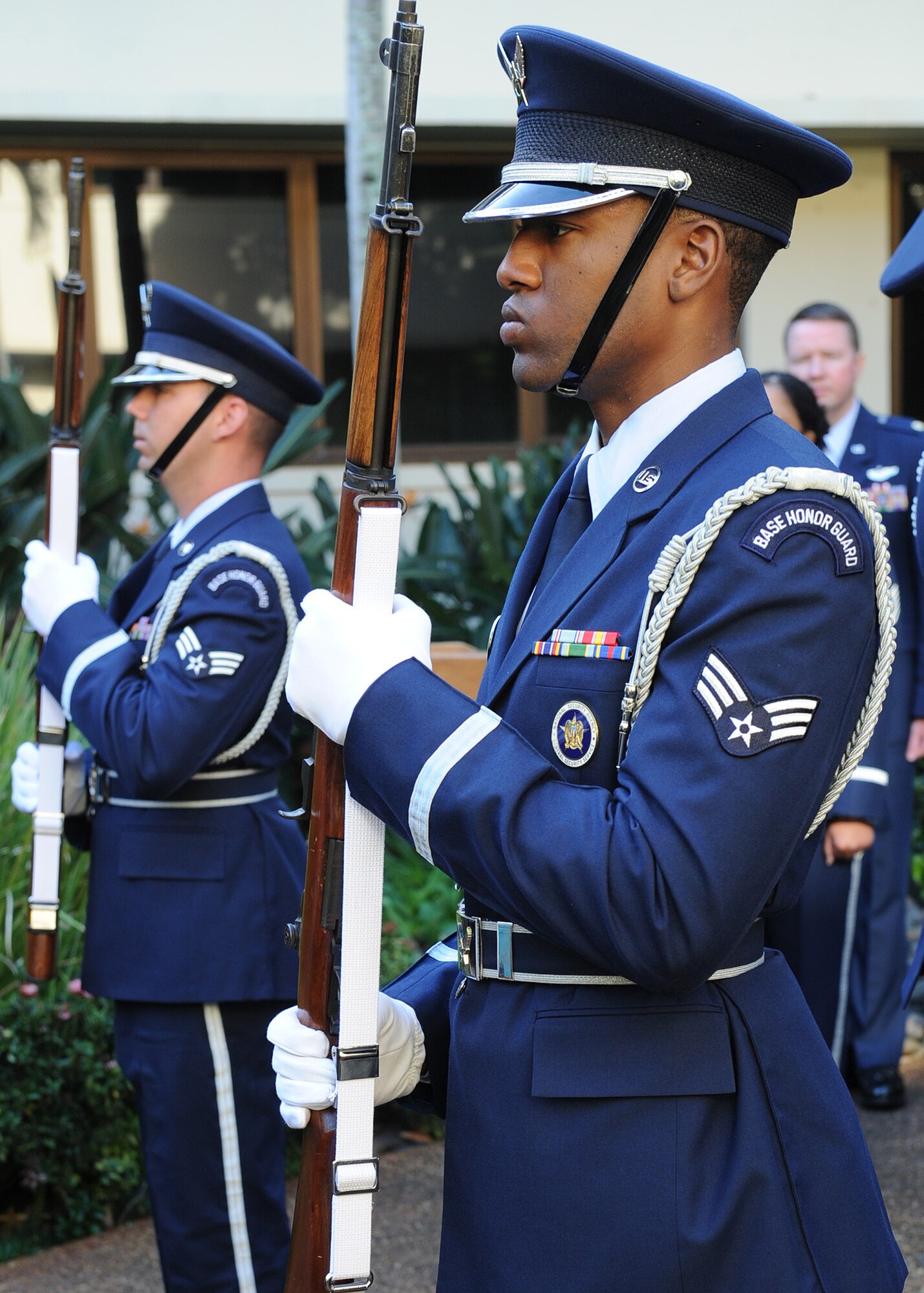 Base honor guard team members stand guard during the posting of the colors at the promotion ceremony for Lt. Gen. Jan-Marc Jouas, Pacific Air Forces director of operations, plans, requirements and programs, in the Courtyard of Heroes, PACAF Headquarters building, Joint Base Pearl Harbor-Hickam, Hawaii, Dec. 9, 2011. Jouas will move on to become the deputy commander, United Nations Command Korea; deputy commander, U.S. Forces Korea; commander, Air Component Command, Republic of Korea/U.S. Combined Forces Command; and commander, 7th Air Force, Pacific Air Forces, at Osan Air Base, South Korea. (U.S. Air Force photo/Tech. Sgt. Jerome S. Tayborn/Released) 