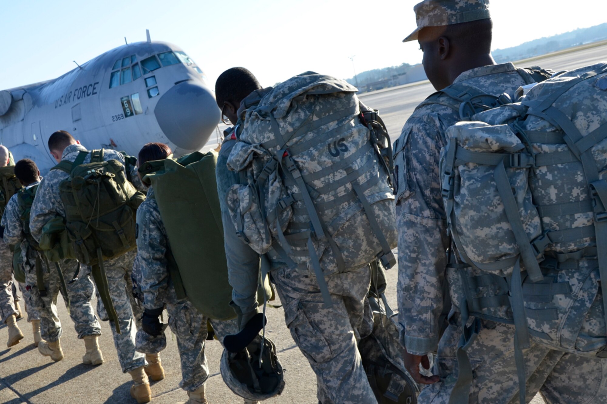 Members of the Army 382nd Combat Camera, East Point, Ga., prepare to board a Dobbins Air Reserve Base C-130 in route to Fort Bragg, N.C. in support of Operation Toy Drop. The unit will document approximately 4000 paratroopers from the U.S. Army Civil Affairs and Psychological Operations Command, 18th Airborne Corps and visiting paratroopers from 11 countries as they parachute and deliver new, unwrapped toys to be distributed to local children's homes and social service agencies. (U.S. Air Force photo/Master Sgt. James Branch)