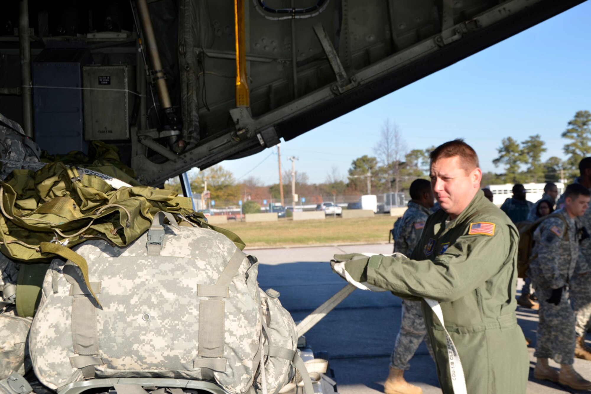 Master Sgt. Peter A. Kowalski, 700th Airlift Squadron loadmaster, assists members of the Army 382nd Combat Camera, East Point, Ga., with loading their gear before taking off to Fort Bragg, N.C. in support of Operation Toy Drop. Approximately 4000 paratroopers from the U.S. Army Civil Affairs and Psychological Operations Command, 18th Airborne Corps and visiting paratroopers from 11 countries will parachute from Dobbins’ and other aircraft and deliver new, unwrapped toys to be distributed to local children's homes and social service agencies. (U.S. Air Force photo/Master Sgt. James Branch)