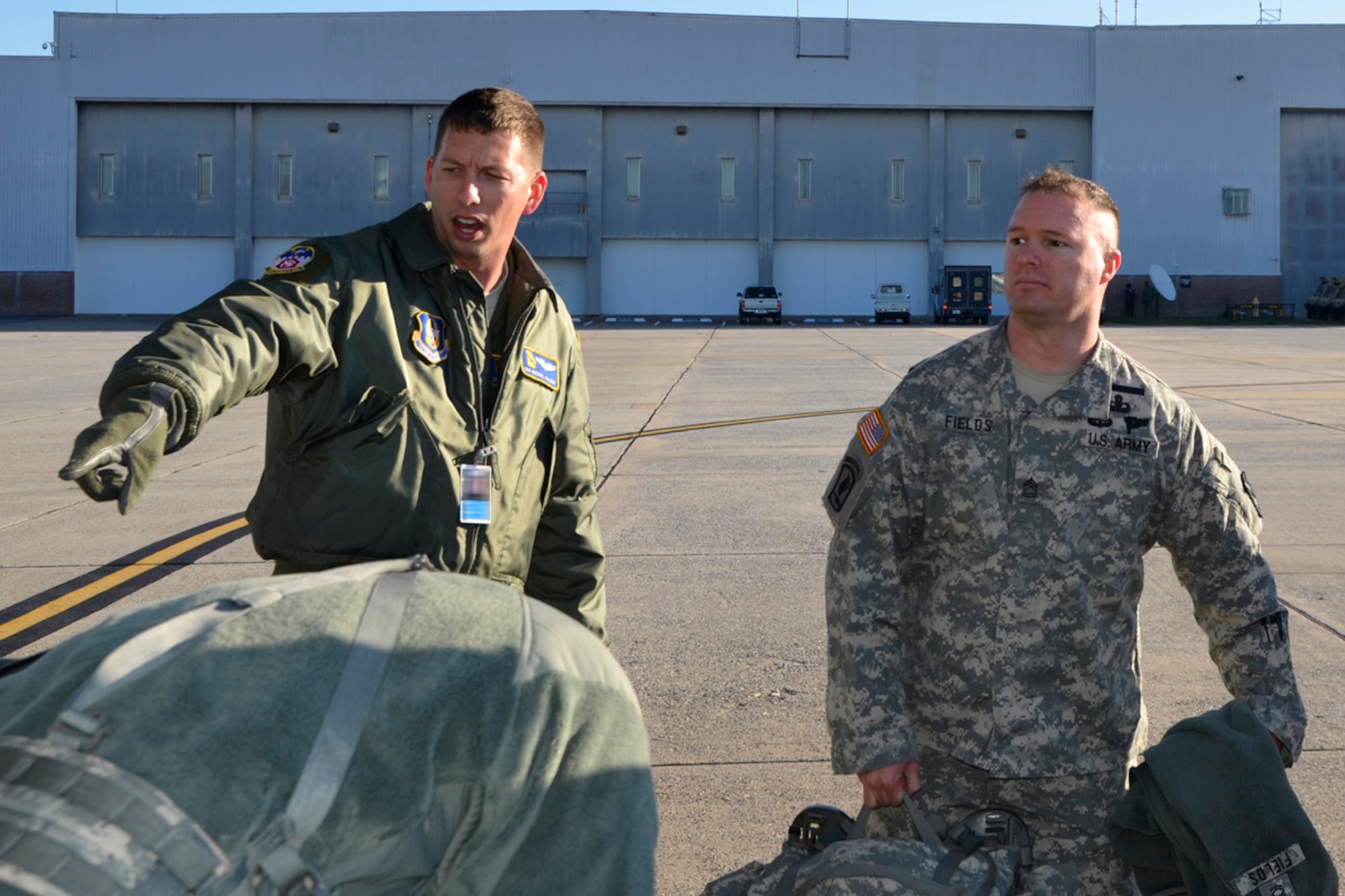Senior Airman Michael J. Sterchi, 700th Airlift Squadron loadmaster, assists members of the Army 382nd Combat Camera, East Point, Ga., with loading their gear before taking off to Fort Bragg, N.C. in support of Operation Toy Drop. Approximately 4000 paratroopers from the U.S. Army Civil Affairs and Psychological Operations Command, 18th Airborne Corps and visiting paratroopers from 11 countries will parachute from Dobbins’ and other aircraft and deliver new, unwrapped toys to be distributed to local children's homes and social service agencies. (U.S. Air Force photo/Master Sgt. James Branch)