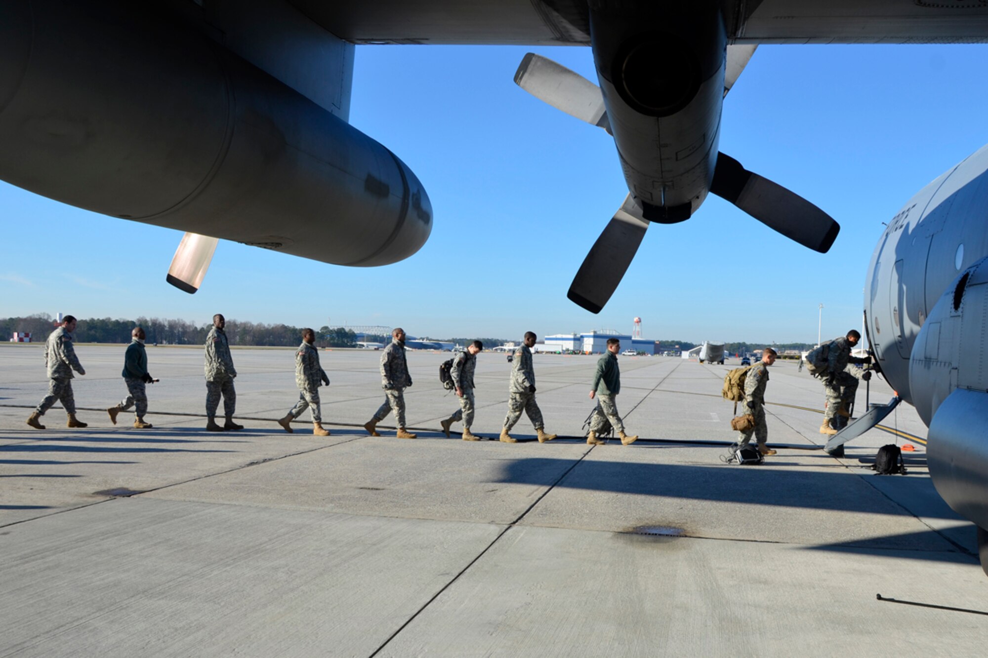 Members of the Army 382nd Combat Camera, East Point, Ga., board a Dobbins Air Reserve Base C-130 in route to Fort Bragg, N.C. in support of Operation Toy Drop. The unit will document approximately 4000 paratroopers from the U.S. Army Civil Affairs and Psychological Operations Command, 18th Airborne Corps and visiting paratroopers from 11 countries as they parachute and deliver new, unwrapped toys to be distributed to local children's homes and social service agencies. (U.S. Air Force photo/Master Sgt. James Branch)