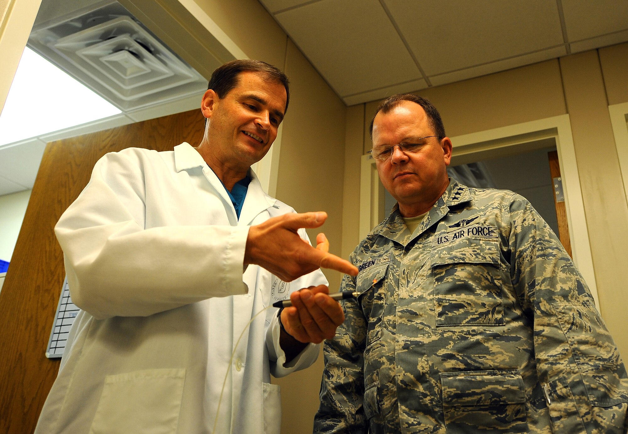 U.S. Air Force Col. Vince Takacs showcases a surgical laser used in dental surgery to U.S. Air Force Surgeon General Lt. Gen. C. Bruce Green, while going through an extensive tour of Ehrling Bergquist Clinic at Offutt Air Force Base, Neb., Dec. 1. Surgical lasers along with other equipment advancements were important points of interest during the general's tour. (U.S. Air Force photo by Josh Plueger/Released).