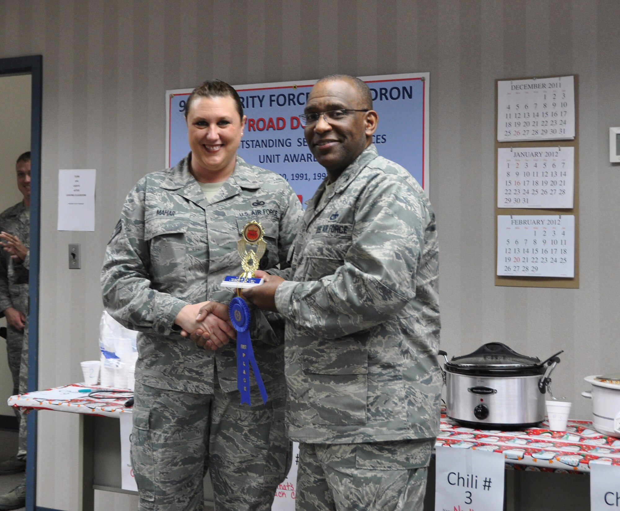 Staff Sgt. Amy Mahar of the Security Forces Squadron is awarded the first place prize during the second annual chili cook-off here Dec. 9.  Mahar named her chili “Ma Hare Core Chili” (U.S. Air Force photo/ Senior Airman Danielle Purnell)