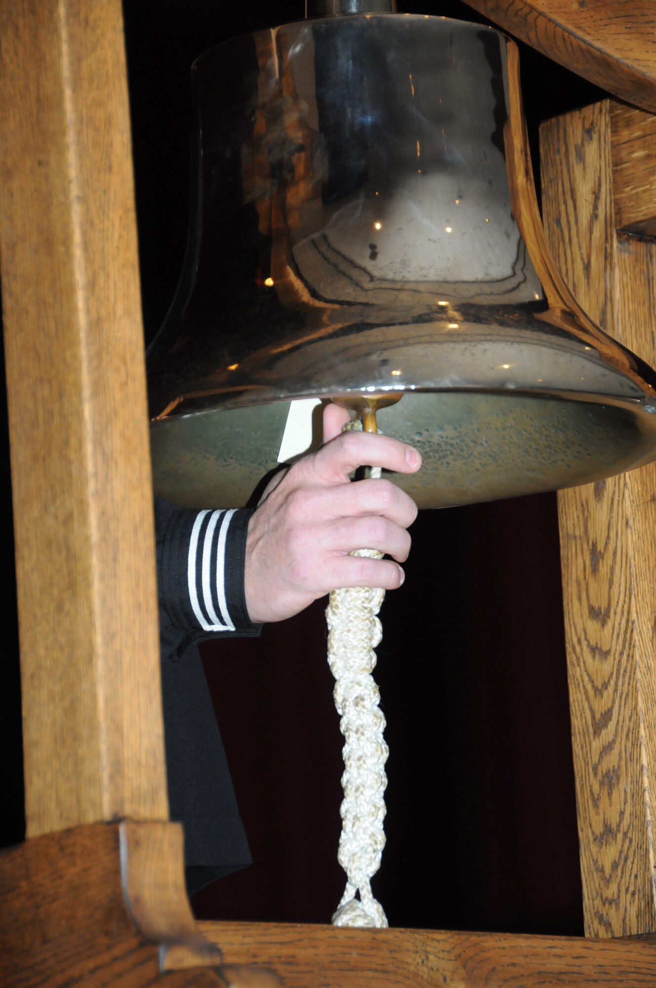 Petty Officer 1st Class Andrew Trapp, Center for Naval Aviation Technical Training Unit, Rings the bell one time for every ship destroyed during the Dec. 7, 1941 Pearl Harbor attacks during a Pearl Harbor Remembrance Ceremony at the Welch Theater at Keesler Air Force Base, Miss., Dec. 7, 2011.  The event also had a guest speaker, retired Gunners Mate, Chief Petty Officer Hugh Wingo and observed a moment of silence for the lost lives of that day.  (U.S. Air Force photo by Kemberly Groue)