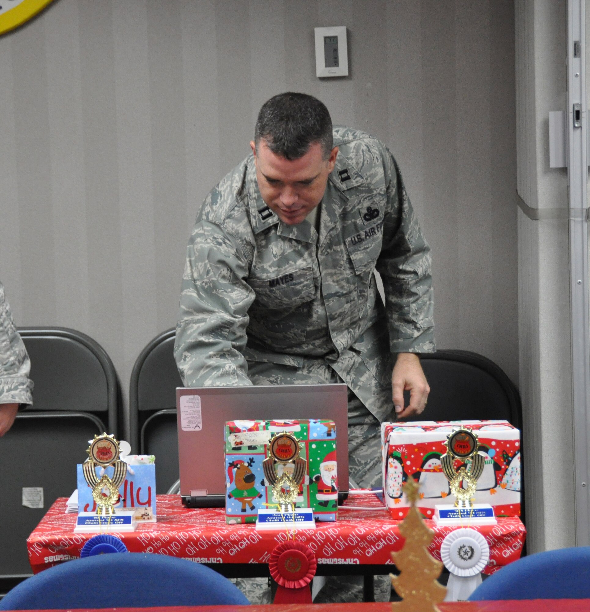 Capt. Robert Mayes, operations officer of the 94th Security Forces Squadron tallies up the final scored during the second annual chili cook-off here Dec. 9.  First, second and third place awards were given to the top-rated chili. (U.S. Air Force photo/ Senior Airman Danielle Purnell)
