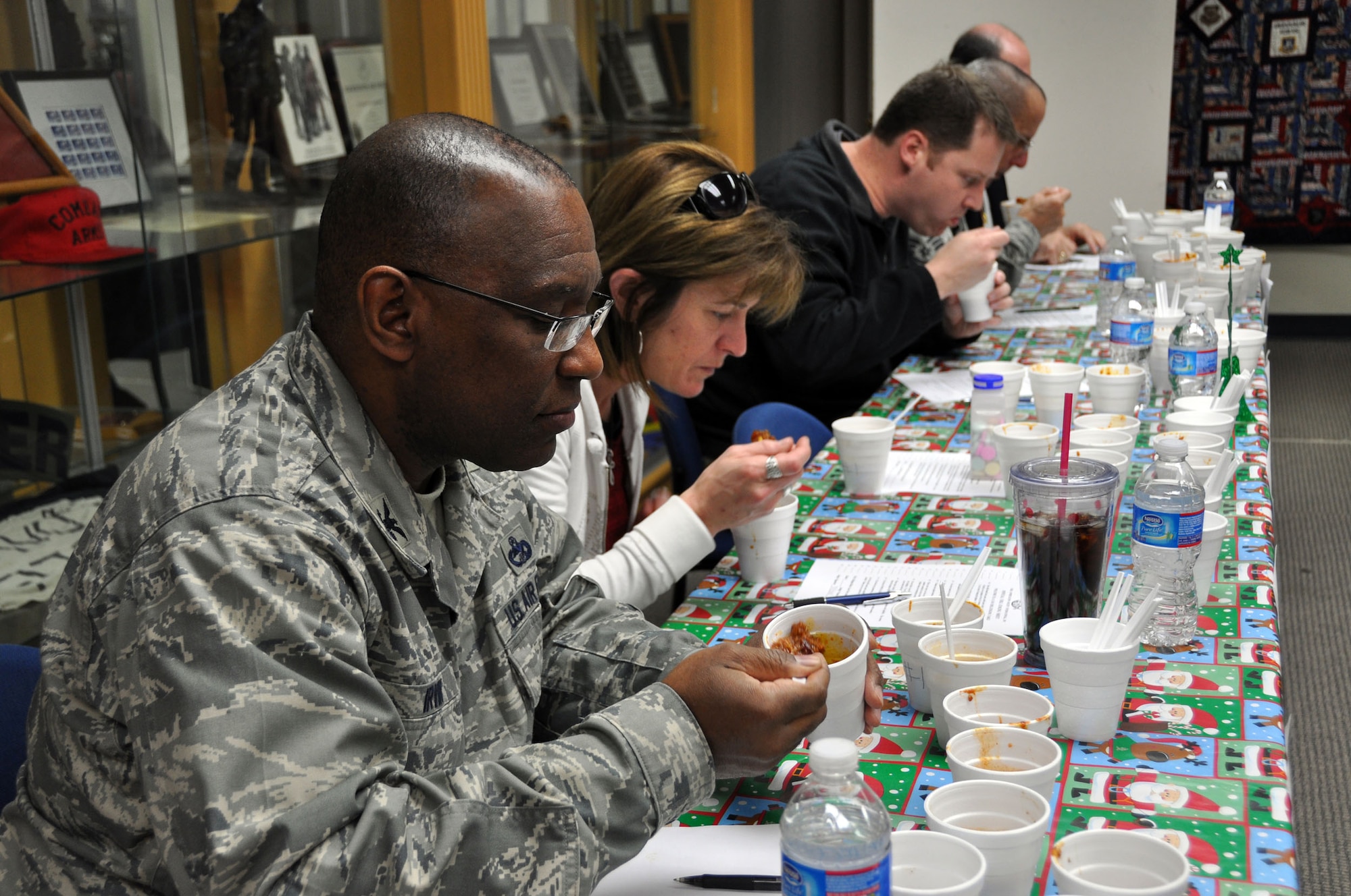 Col. Marshall S. Irvin, the commander of the 94th Mission Support Group, and other judges taste test the chili cook-off entries of the 94th Security Forces Squadron here Dec. 9.  This was the SFS second year hosting this event. (U.S. Air Force photo/ Senior Airman Danielle Purnell)
