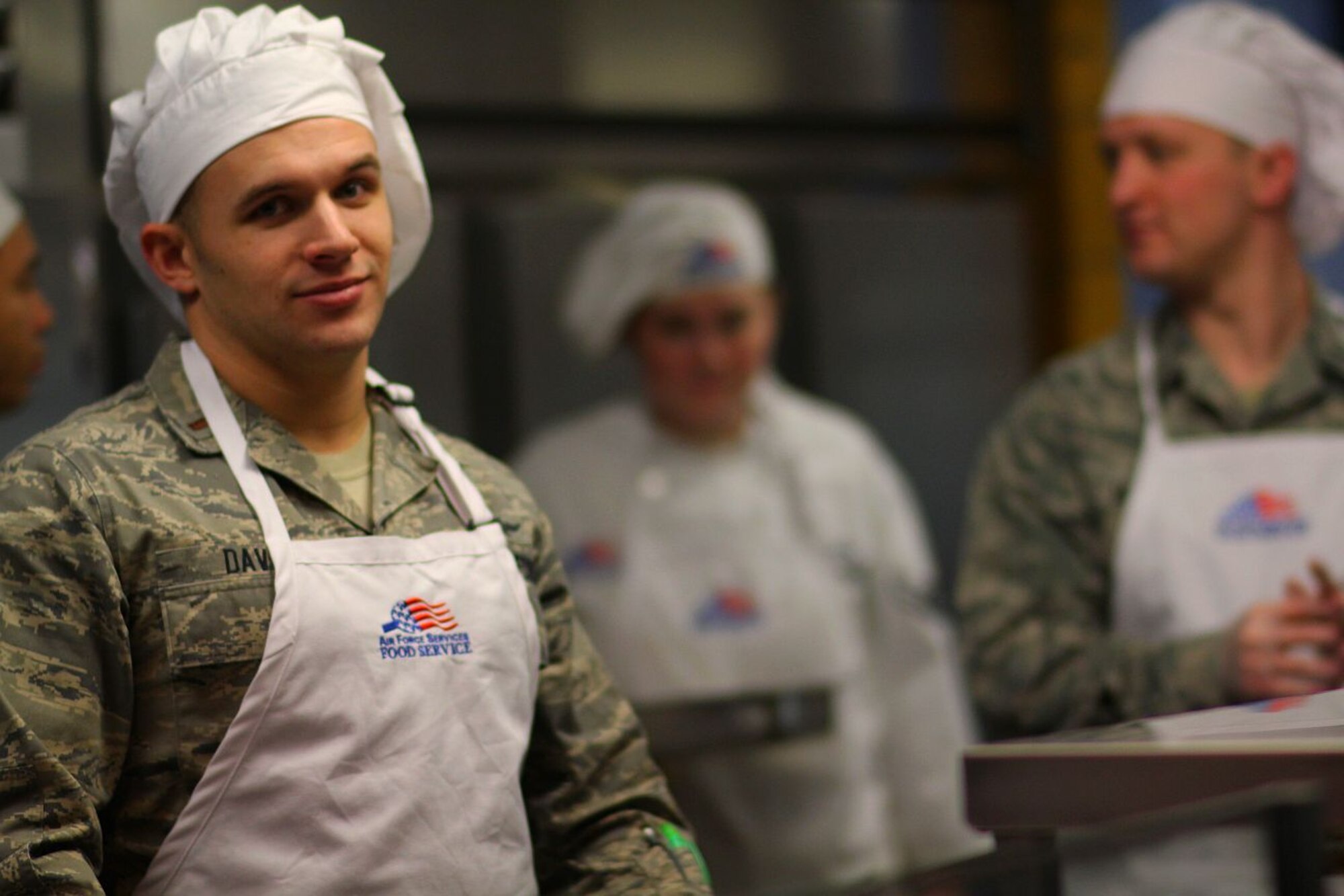 MINOT AIR FORCE BASE, N.D. -- 2nd Lt. Gregory Davis, 5th Communications Squadron, volunteers his time at the Dining Facility here to serve young enlisted Airmen meals. The officers provide this monthly community service as part of the Minot AFB Company Grade Officers’ Council outreach. (U.S. Air Force photo/ Capt. Jon Arceta)