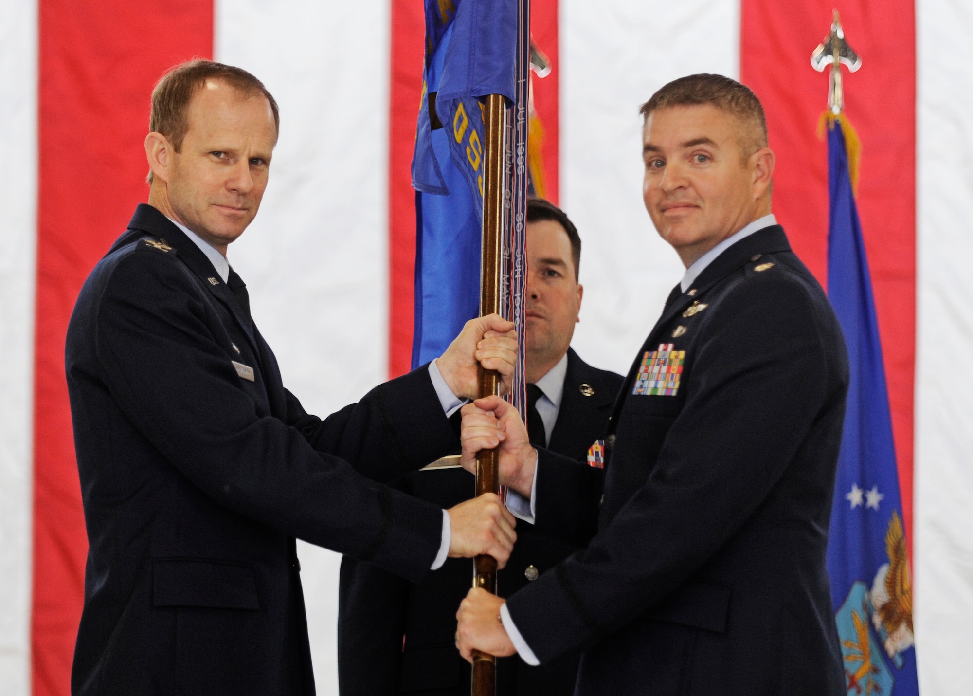 Lt. Col. William Buschur accepts the unit guidon from Colonel Peter Giusti, Operations Group Commander, as he assumes command of the 375th Operation Support Squadron from Lt. Col. Sara Beyer during a change of command ceremony at Scott Air Force Base, IL Dec. 6. Colonel Buschur previously served as the director of operations for the 375th OSS. (U.S. Air Force photo/Staff Sgt. Ryan Crane)