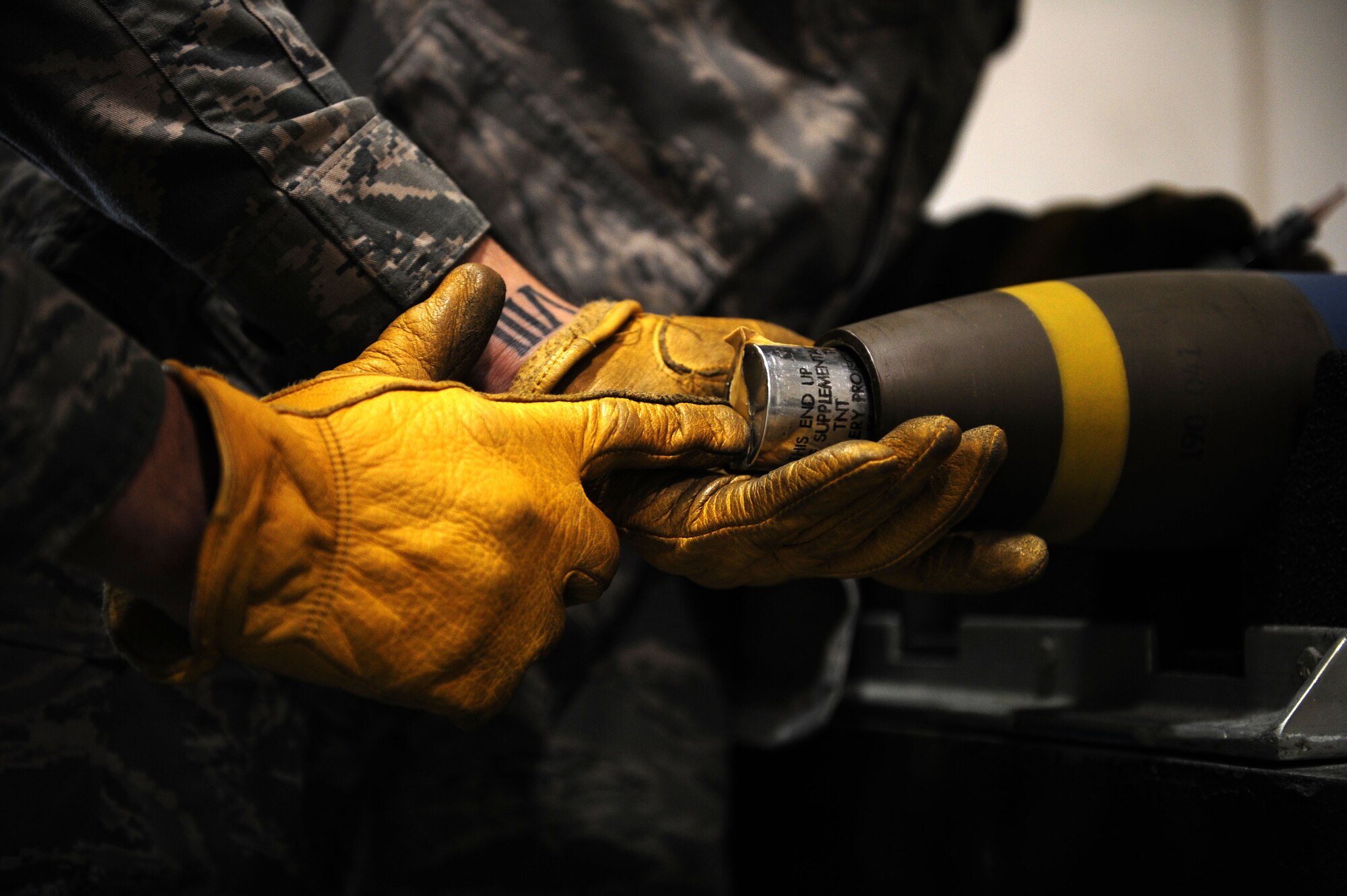 U.S. Air Force Airman 1st Class Brian O?Donnell, 1st Special Operations Equipment Maintenance Squadron munitions system apprentice, places the charge of a 105 millimeter target practice round back into its shell on Hurlburt Field Fla., Nov. 29, 2011.  Approximately 2900 105 millimeter target practice shells must have their corroded fuses swapped for the first time by O'Donnell and his fellow Airmen. (U.S. Air Force photo/Airman 1st Class Gustavo Castillo)(Released)
