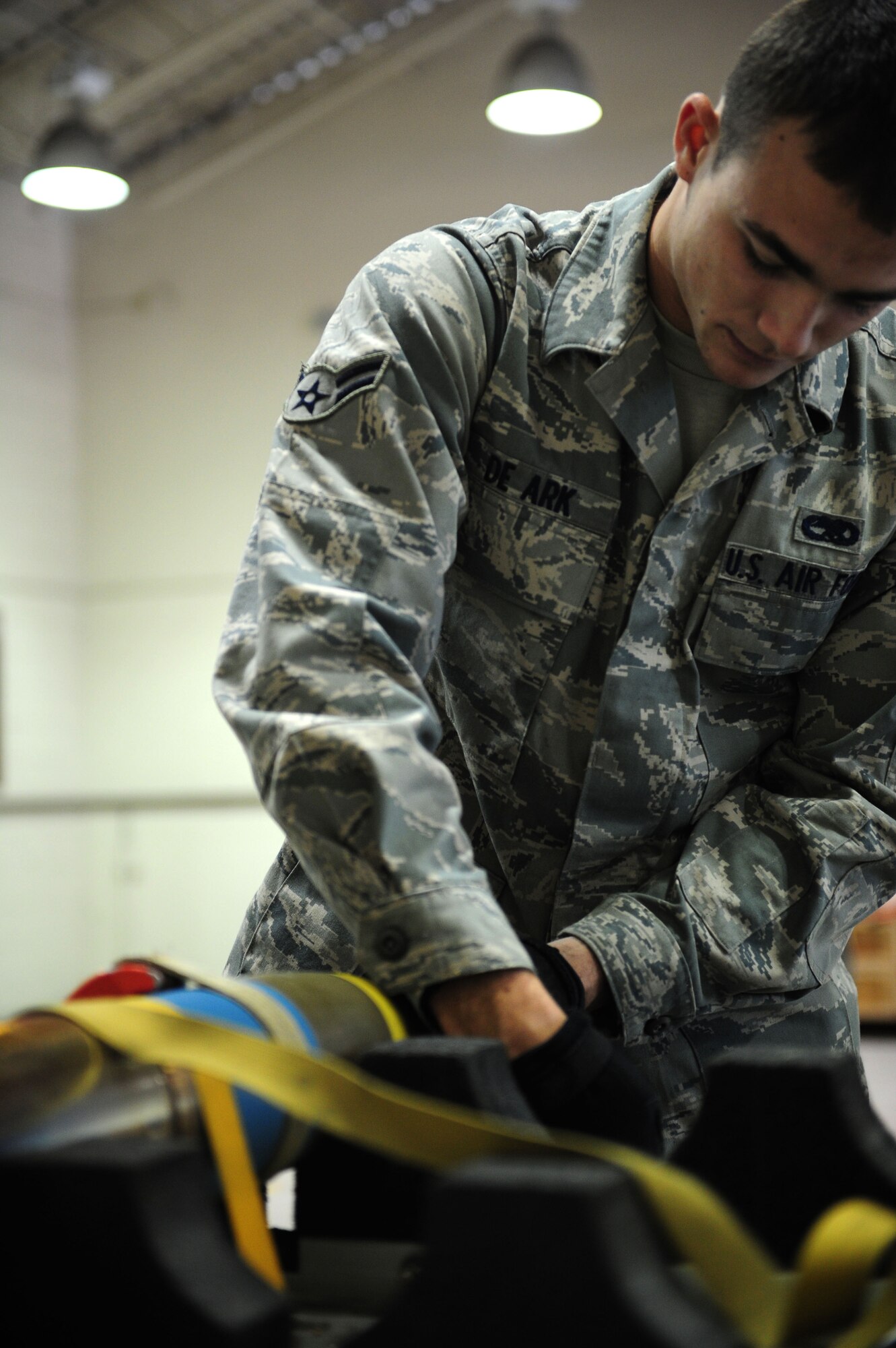 U.S. Air Force Airman 1st Class Cody De Ark, 1st Special Operations Equipment Maintenance Squadron munitions system apprentice, removes the head of a 105 millimeter target practice shell on Hurlburt Field Fla., Nov. 29, 2011.  The shell must have the inside components removed and cleaned during the process of replacing the corroded fuse for a clean one. (U.S. Air Force photo/Airman 1st Class Gustavo Castillo)(Released) 