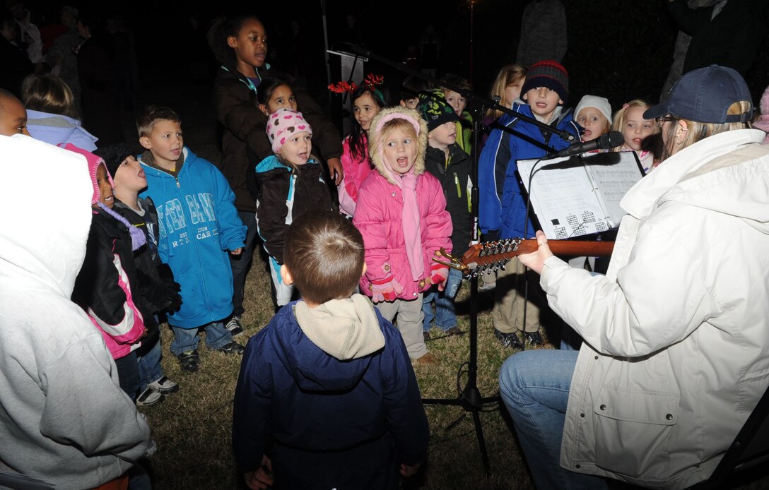 Children sing “Here Comes Santa Claus” during the 44th Annual Christmas tree lighting ceremony at the base chapel on Langley Air Force Base, Va., Dec. 8, 2011. Families gathered during the ceremony on the chapel lawn, sang seasonal carols and waited for a special visit from Santa Claus. (U.S. Air Force Photo by Airman 1st Class Racheal Watson)