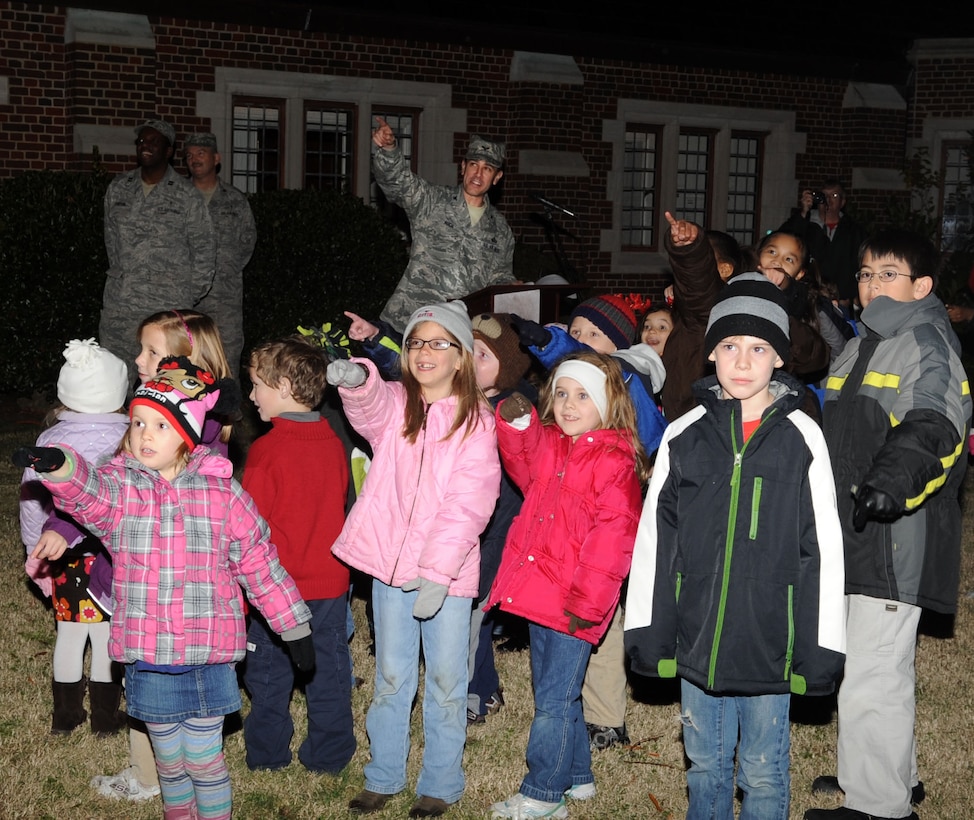 Col. Korvin Auch, 633rd Air Base Wing commander, joins children as they signal the lighting of the tree during the 44th Annual Christmas tree lighting ceremony at the base chapel on Langley Air Force Base, Va., Dec. 8, 2011. Approximately 60 guests attended the ceremony, which signifies the beginning of the holiday season each year. (U.S. Air Force Photo by Airman 1st Class Racheal Watson)