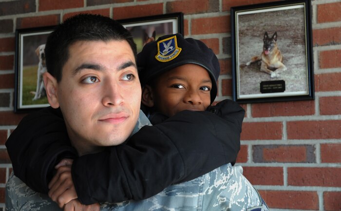 Ja-Rease Skinner and mentor Senior Airmen Vincent Gutierrez take a tour of Joint Base Charleston- Air Base Dec. 8. JB Charleston's Airmen Leadership School invited more than 30 third grade students from Memminger Elementary School to tour the base. This tour is part of an on-going community service project to bring awareness to the opportunities the Air Force has to offer future generations. Gutierrez is from the 628th Security Forces Squadron. (U.S. Air Force photo/Airman 1st Class Ashlee Galloway)