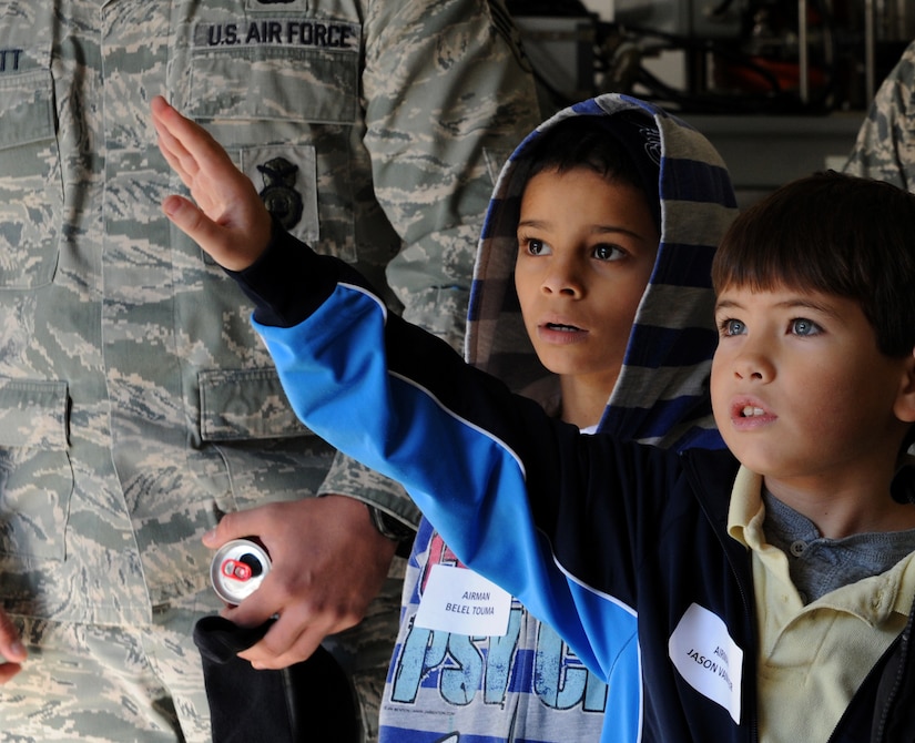 Jason Vanmeir raises his hand to ask a question as he takes a tour of Joint Base Charleston-Air Base, Dec. 8. JB Charleston's Airmen Leadership School invited more than 30 third grade students from Memminger Elementary School to tour the base. The tour is part of an on-going community service project to bring awareness to the opportunities the Air Force has to offer future generations. (U.S. Air Force photo/Airmen 1st Class Ashlee Galloway)