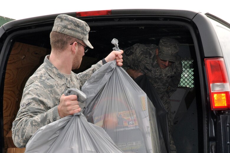 YOUNGSTOWN AIR RESERVE STATION, Ohio – Air Force Reserve Tech. Sgt. Duane Cribley (in the van), a utilities specialist, and Airman Matthew Fenton, an administration specialist, both assigned to the 910th Civil Engineer Squadron, unload bags of toys from a van at the Navy and Marine Center here, Dec. 9, 2011. Sergeant Cribley and Airman Fenton are delivering the toys as part of the 910th Airlift Wing’s involvement in the Toys for Tots program. The wing annually partners with the Marine Corps Reserve unit based here, to collect new, un-wrapped toys for area boys and girls (newborn through 16 years of age) in order to provide a gift for Christmas morning that the children might otherwise not receive. U.S. Air Force photo by Master Sgt. Bob Barko Jr.