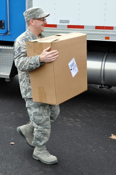 YOUNGSTOWN AIR RESERVE STATION, Ohio – Air Force Reserve Tech. Sgt. Duane Cribley, a utilities specialist assigned to the 910th Civil Engineer Squadron, carries box of new toys to the Navy and Marine Center here, Dec. 9, 2011. Sergeant Cribley is delivering the toys as part of the 910th Airlift Wing’s involvement in the Toys for Tots program. The wing annually partners with the Marine Corps Reserve unit based here, to collect new, un-wrapped toys for area boys and girls (newborn through 16 years of age) in order to provide a gift for Christmas morning that the children might otherwise not receive. U.S. Air Force photo by Master Sgt. Bob Barko Jr.