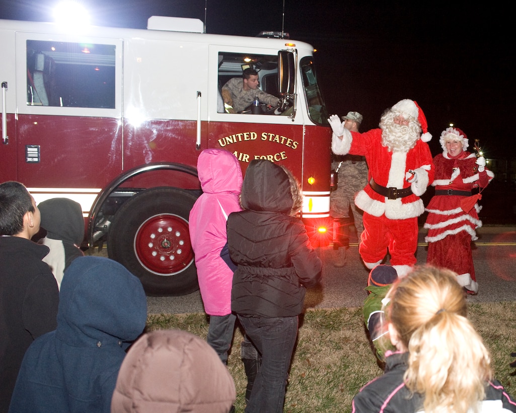 JOINT BASE ANDREWS, Md. -- Santa and Mrs. Claus arrive at Chapel I to a sea of Team Andrews children Dec. 1. The jolly couple arrived courtesy of the 11th Civil Engineer Squadron firefighters after the annual Christmas tree and Hanukah Menorah lighting ceremony. (Photo/Bobby Jones)  